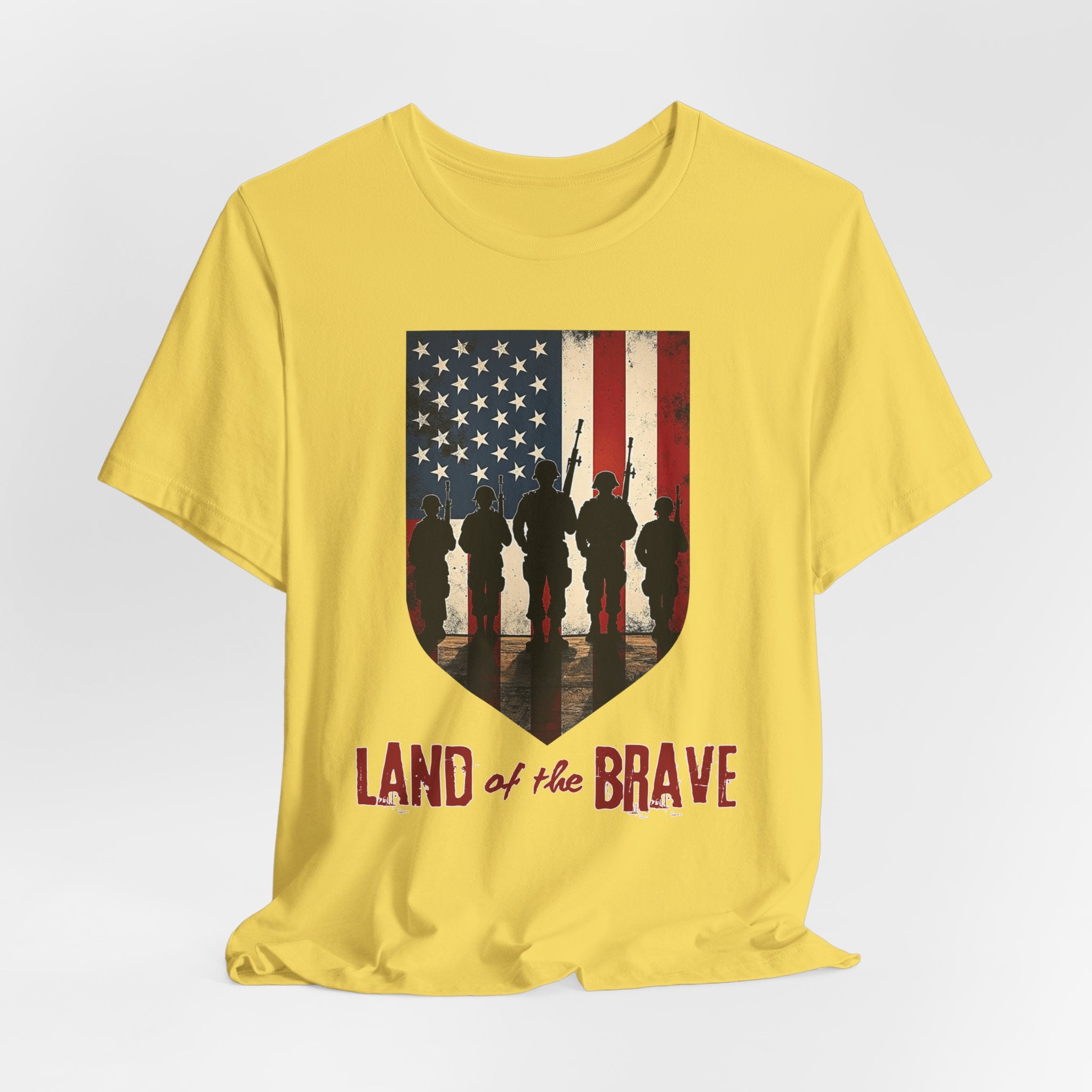 Maze yellow t-shirt with vintage American flag, soldiers, and silhouette design with land of the brave text on a white background