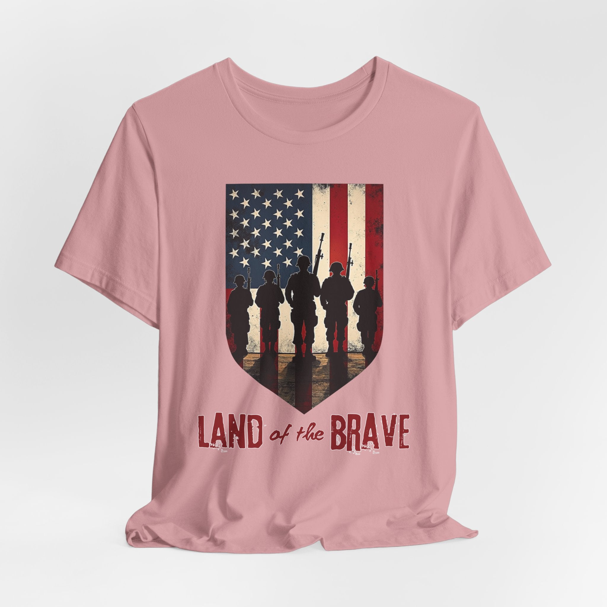 Orchid pink t-shirt with vintage American flag, soldiers, and silhouette design with land of the brave text on a white background