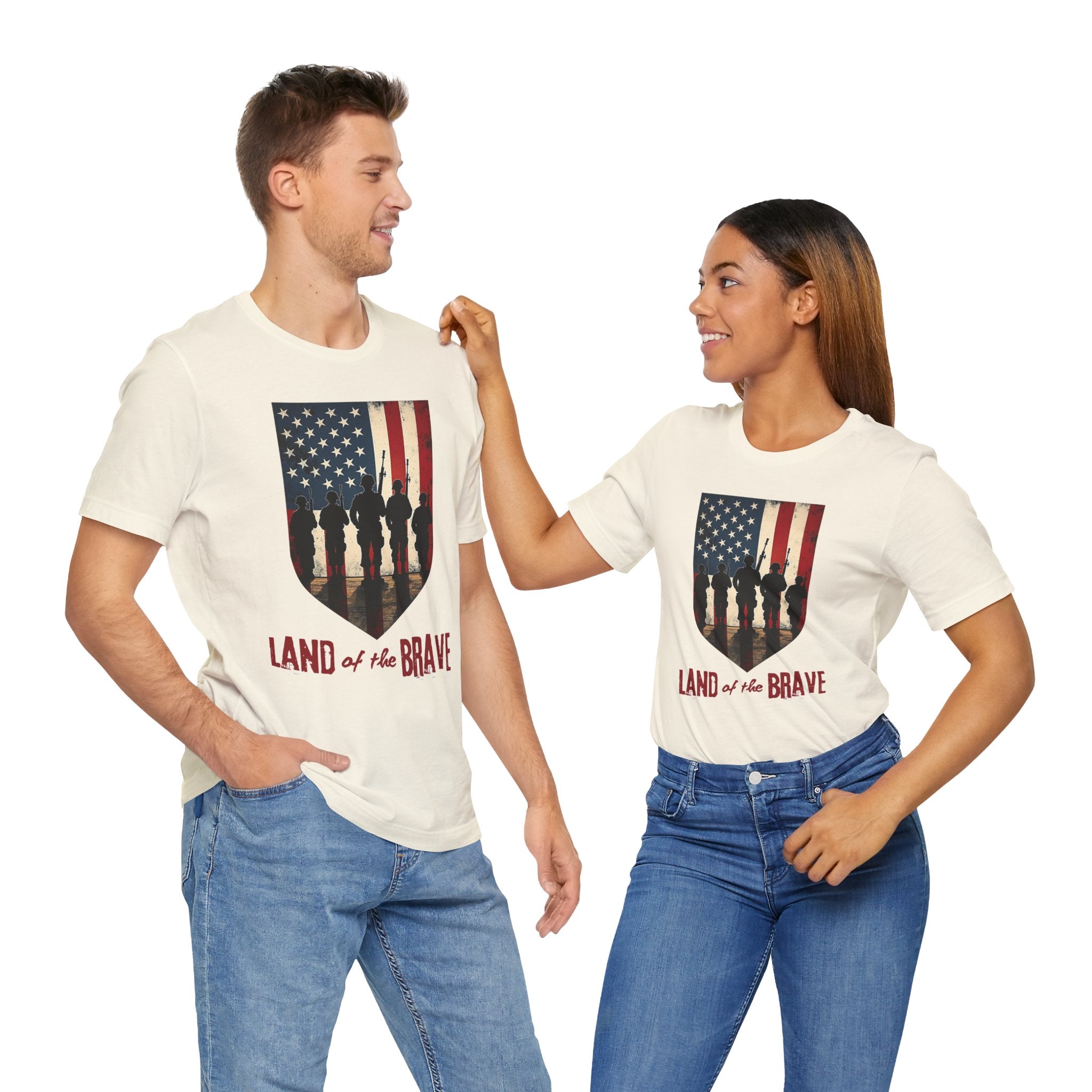 Two people wearing matching t-shirts with an American flag design and 'Land of the Brave' text.