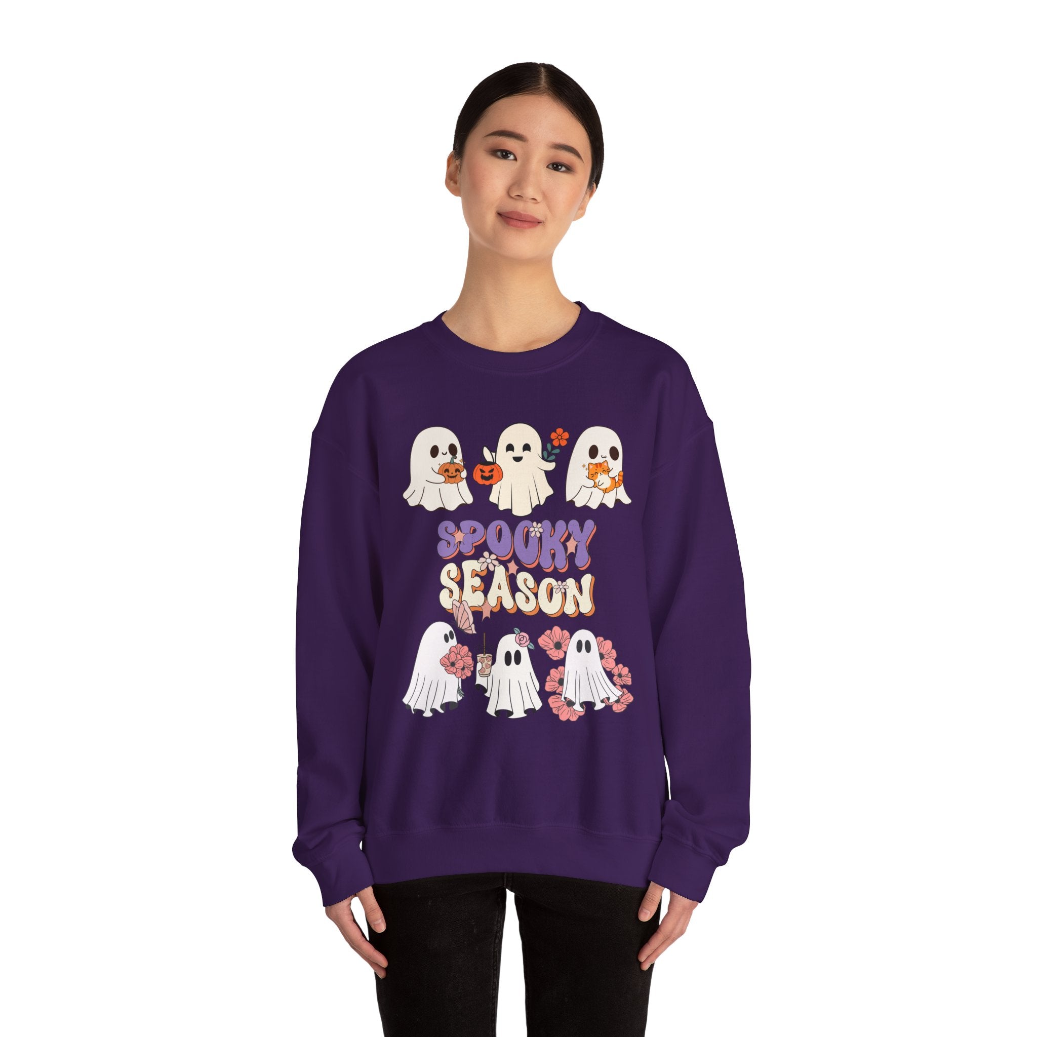 Person wearing a purple sweatshirt with Halloween-themed design on a white background
