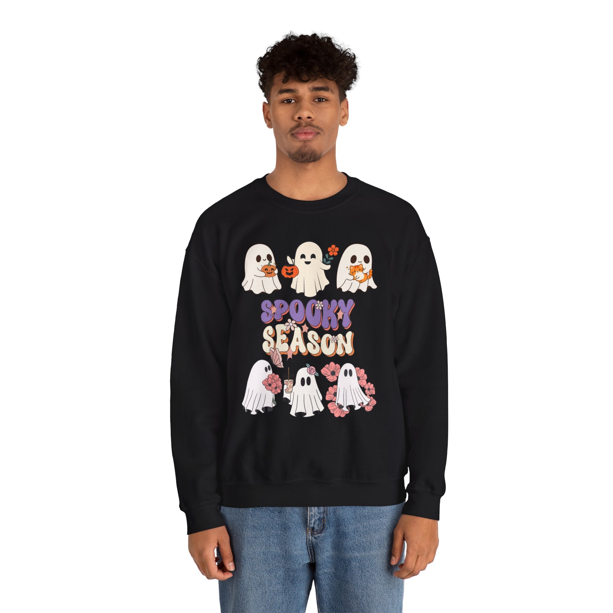 Person wearing a black sweatshirt with Halloween-themed design on a white background