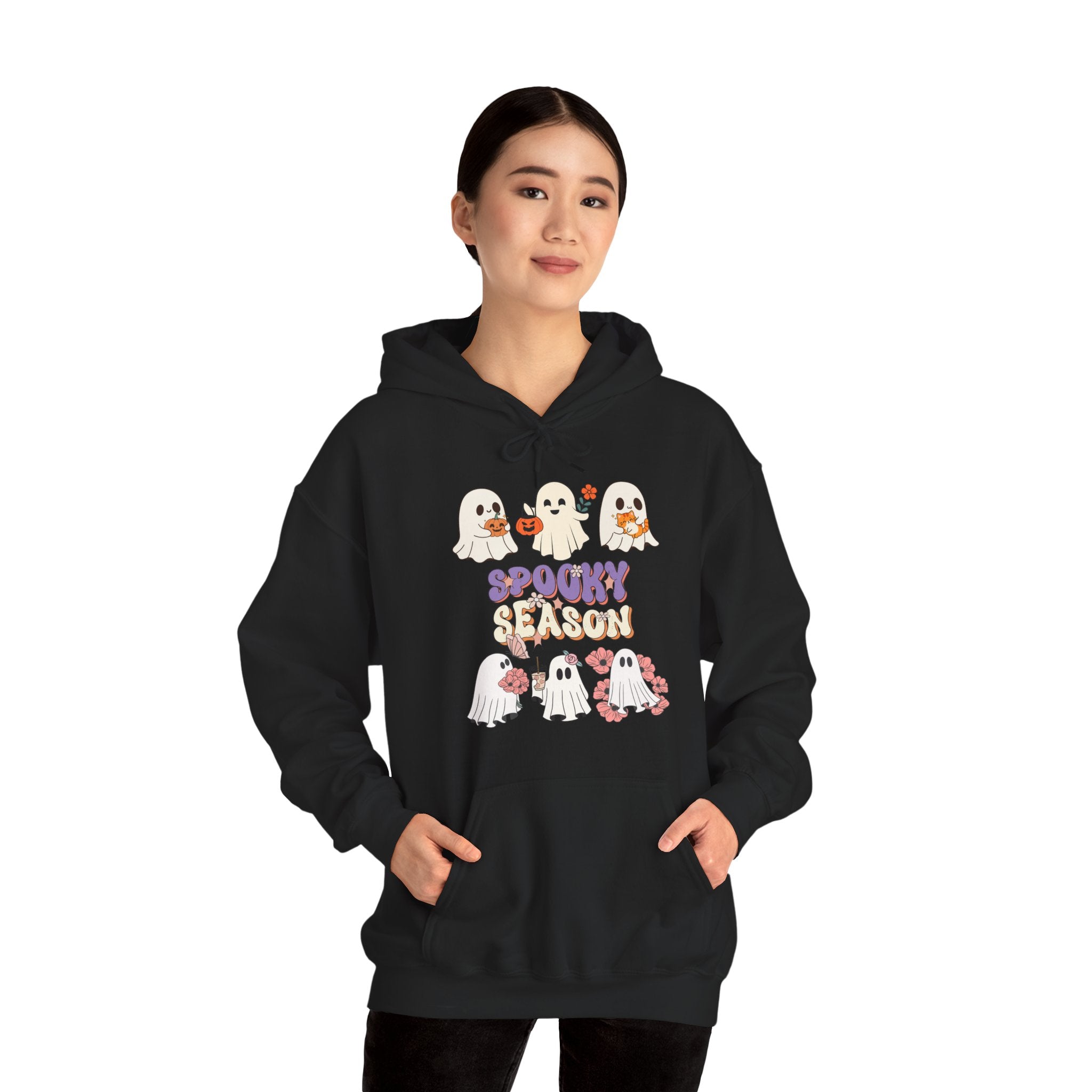 Person wearing a black hoodie with Halloween-themed design on a white background