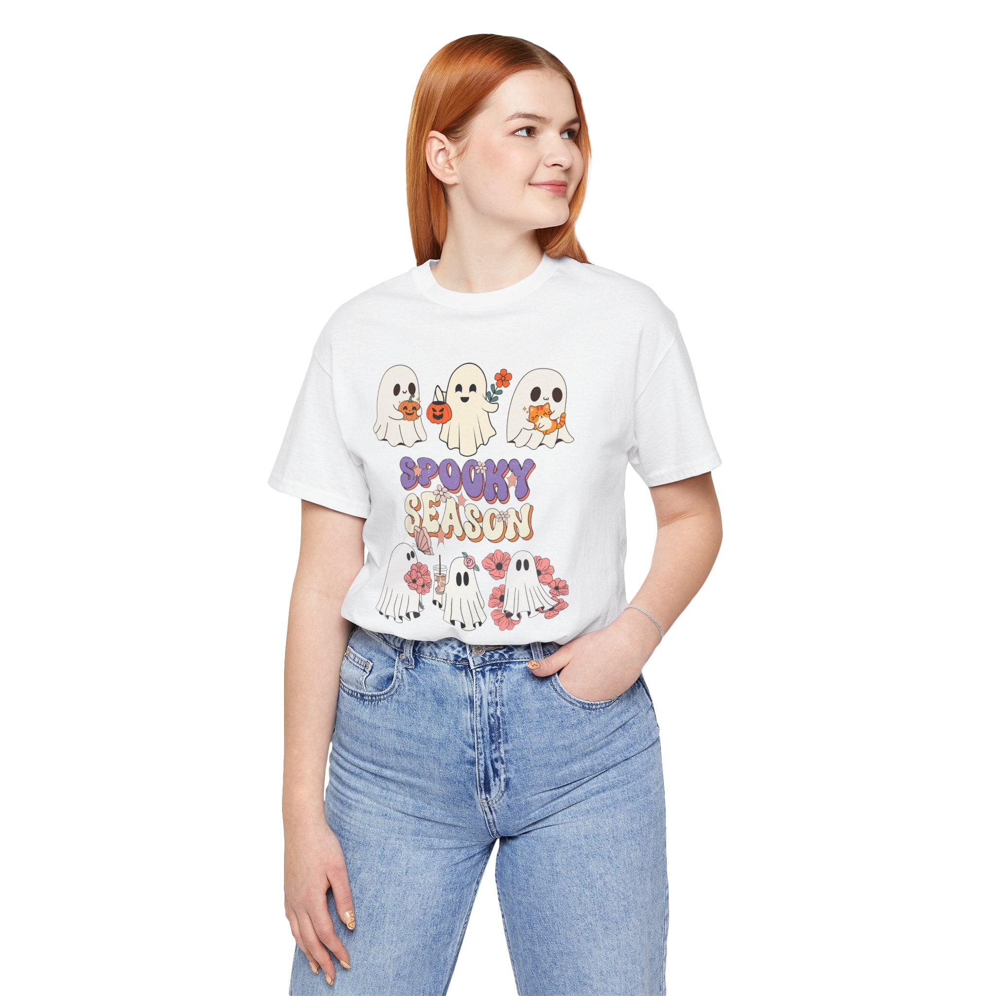 Person wearing a white t-shirt with Halloween-themed graphics and text on a white background