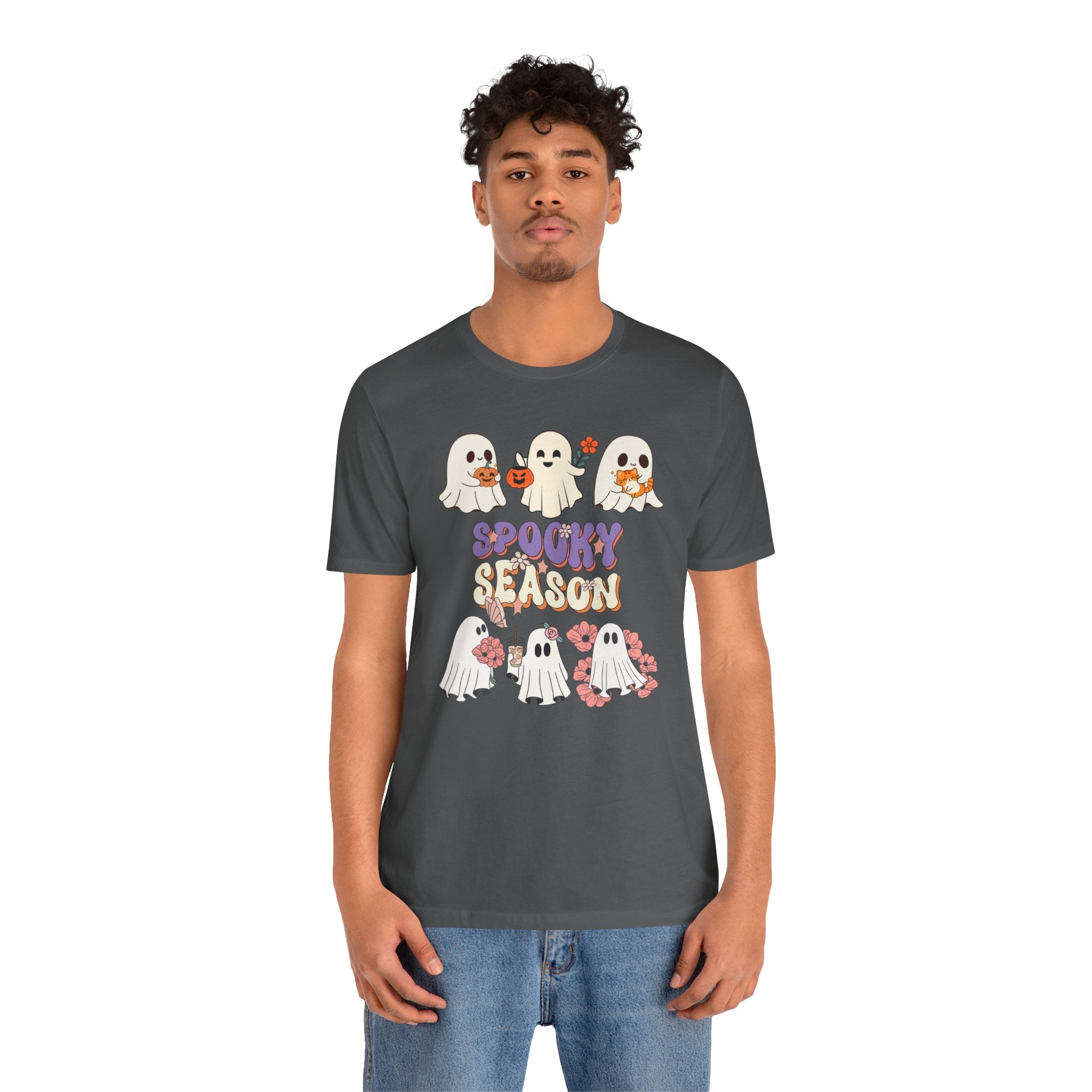 Person wearing a dark gray t-shirt with Halloween-themed design on a white background