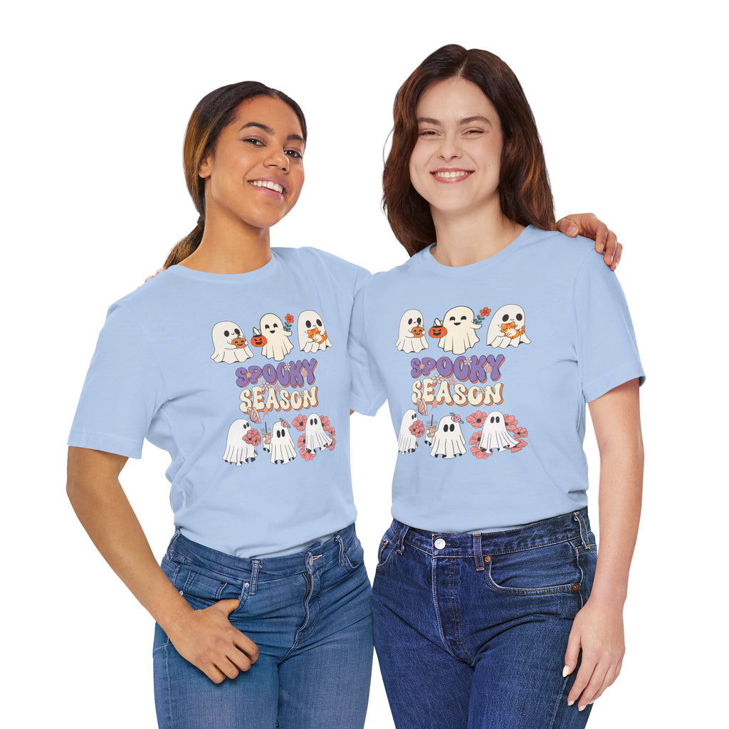 Two people wearing light blue t-shirts with Halloween-themed graphics and text.