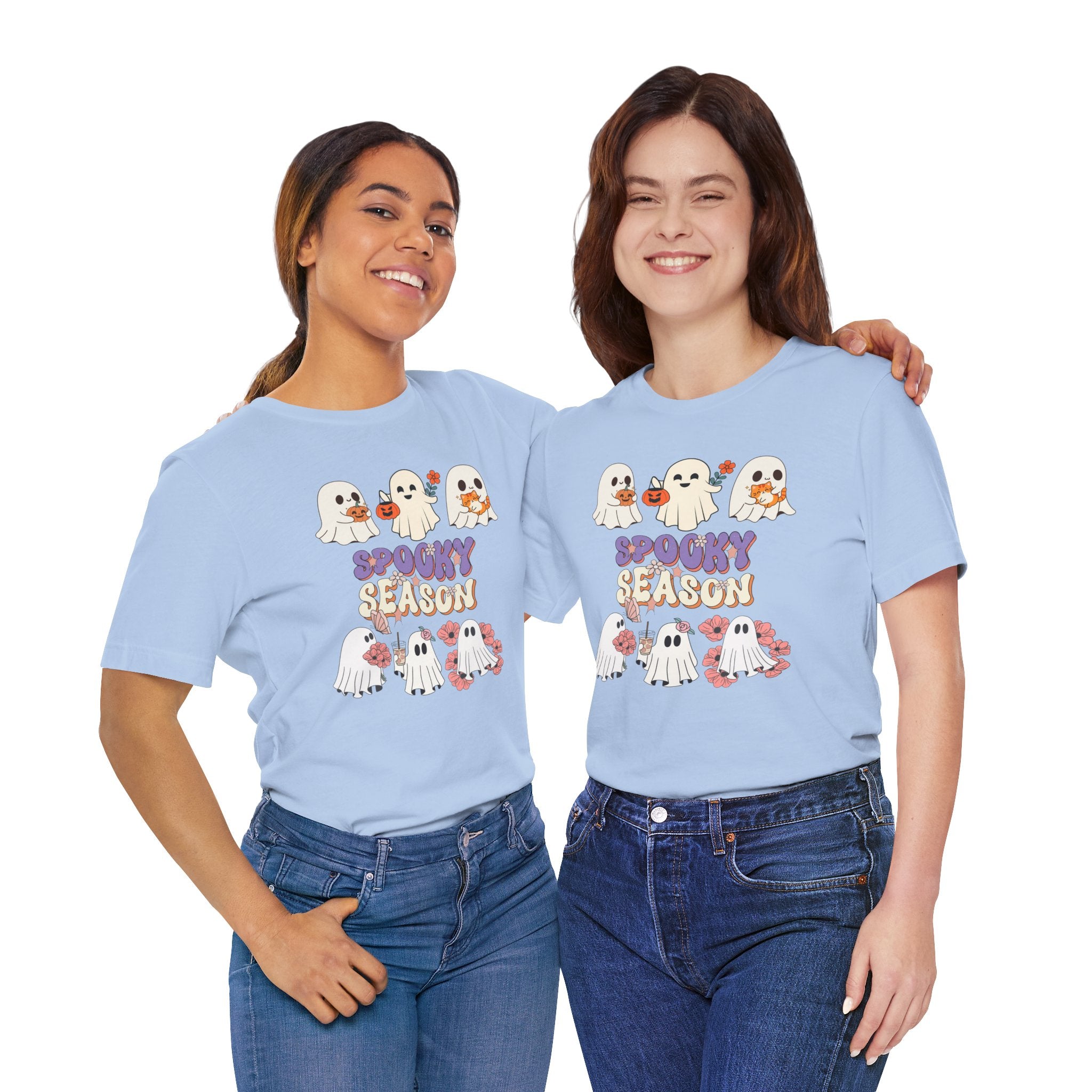 Two people wearing light blue t-shirts with Halloween-themed graphics and text.