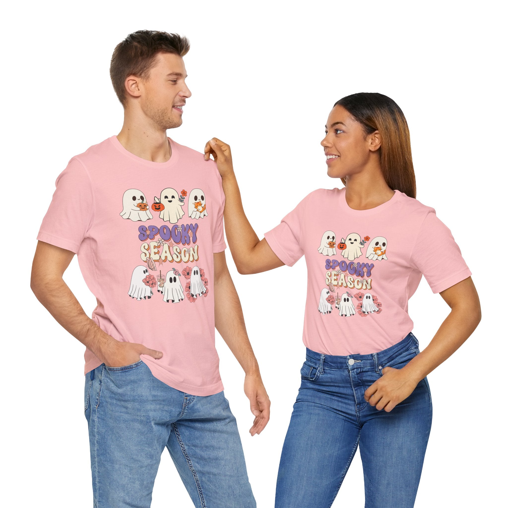 Two people wearing pink 'Spooky Season' t-shirts with ghost graphics on a white background.