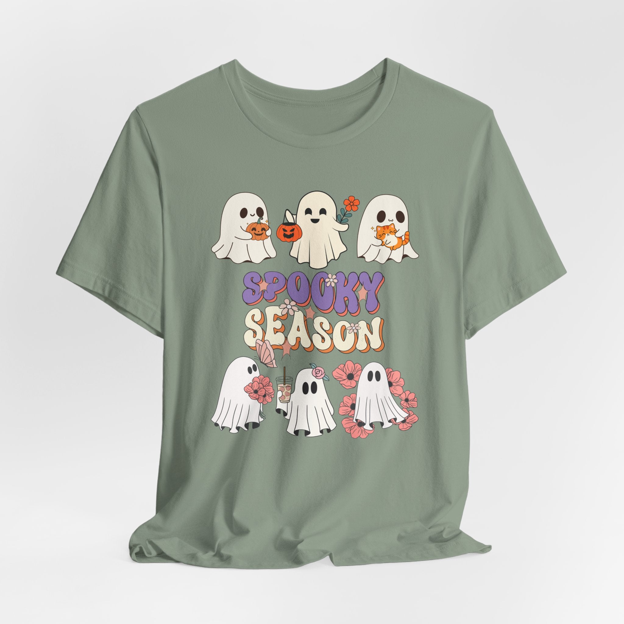 Sage green t-shirt with Halloween-themed design featuring ghosts and 'Spooky Season' text on a white background.