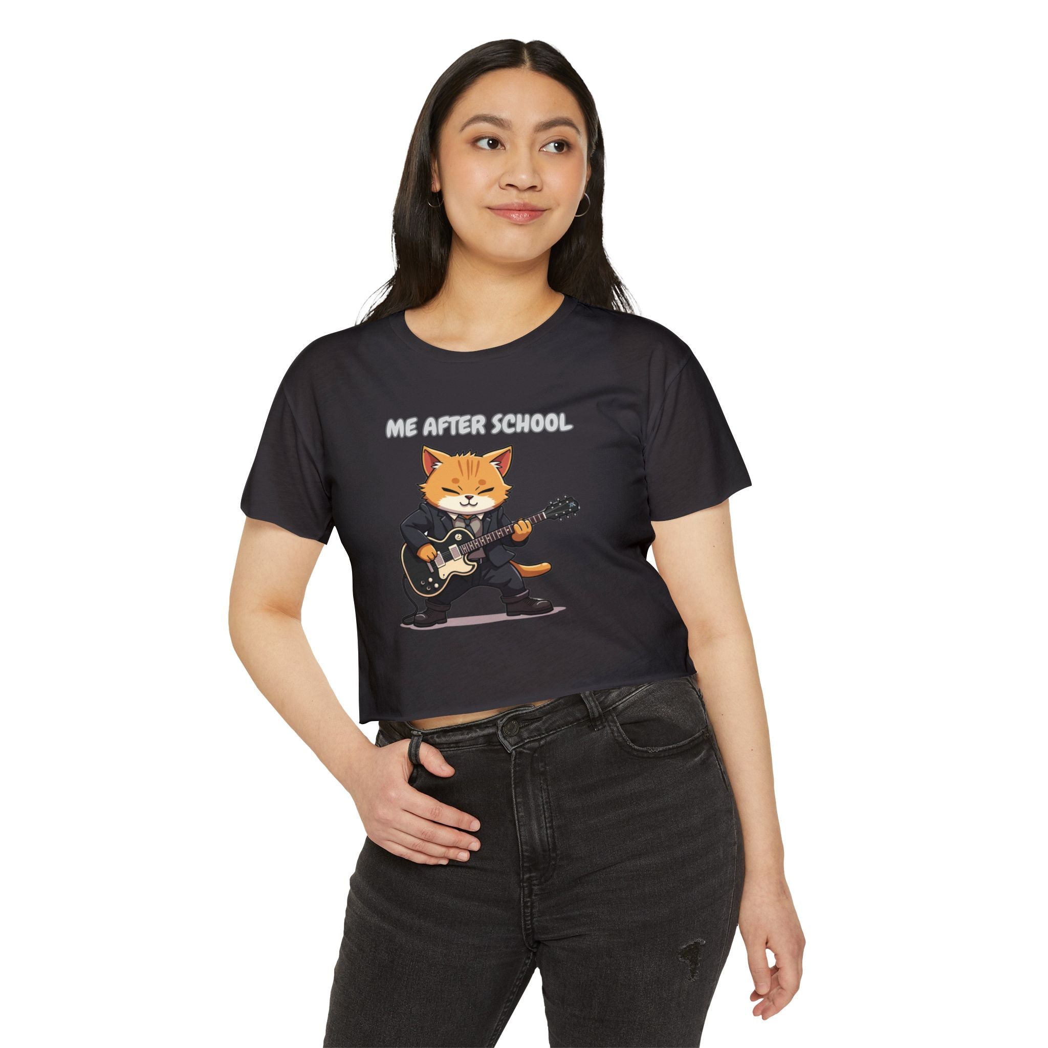 Woman wearing a black t-shirt with a graphic of a cat playing guitar and text 'ME AFTER SCHOOL' on a white background.