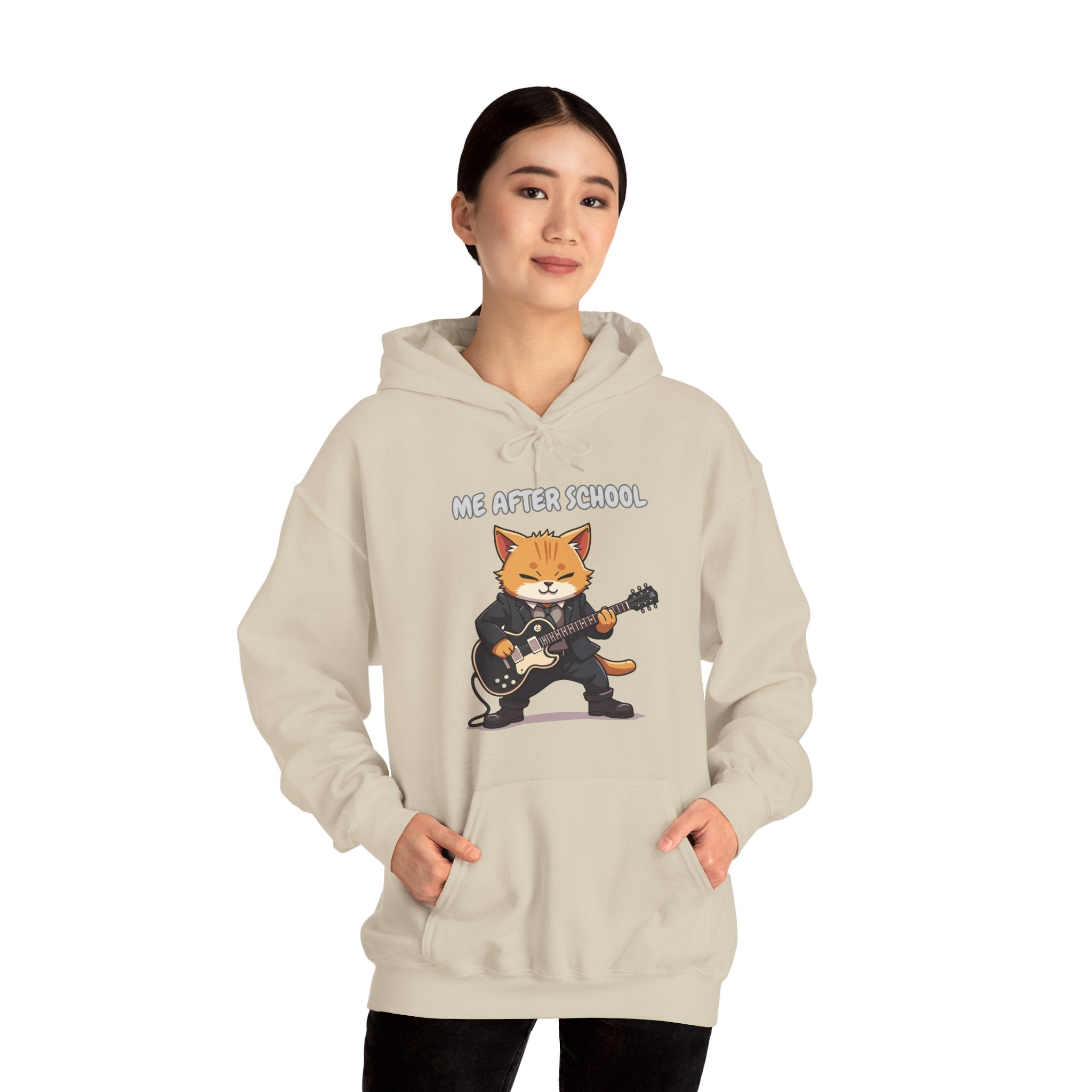 Person wearing a beige hoodie with a graphic of a cat playing guitar and text 'ME AFTER SCHOOL' on a white background