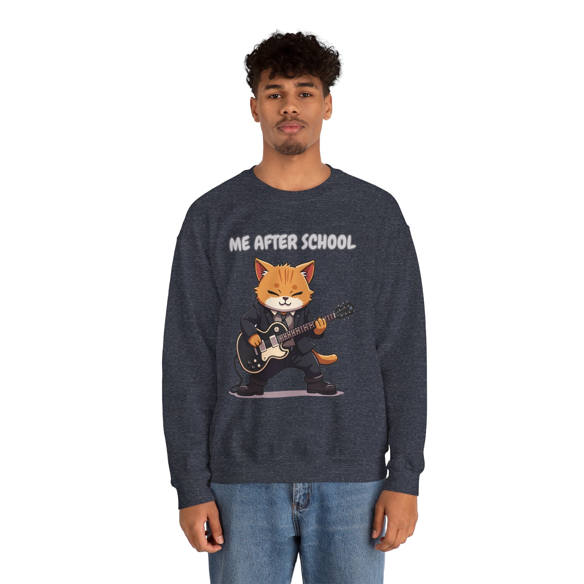 A man wearing heather navy sweatshirt with a cartoon cat playing guitar and 'Me After School' text on a white background