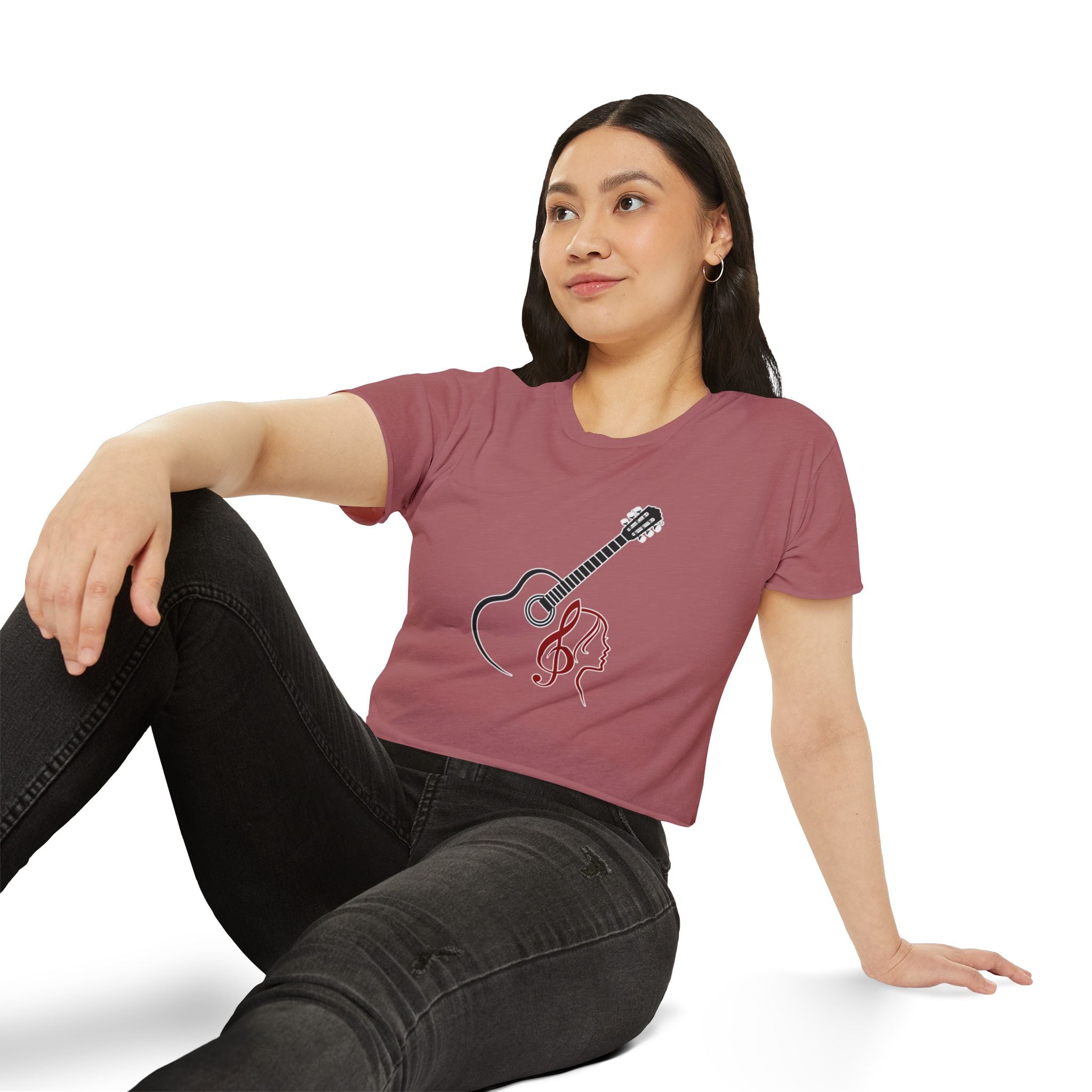 Woman wearing a maroon t-shirt with a guitar and treble clef design on a white background