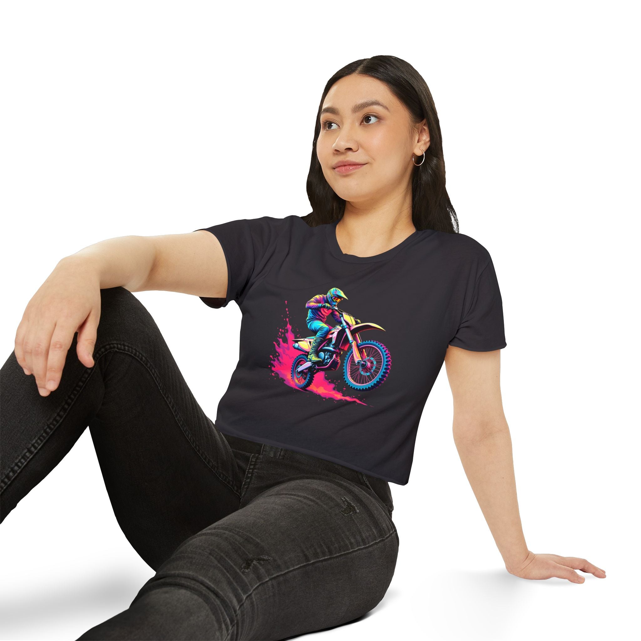 Woman wearing a black t-shirt with a colorful graphic design sitting on a white background