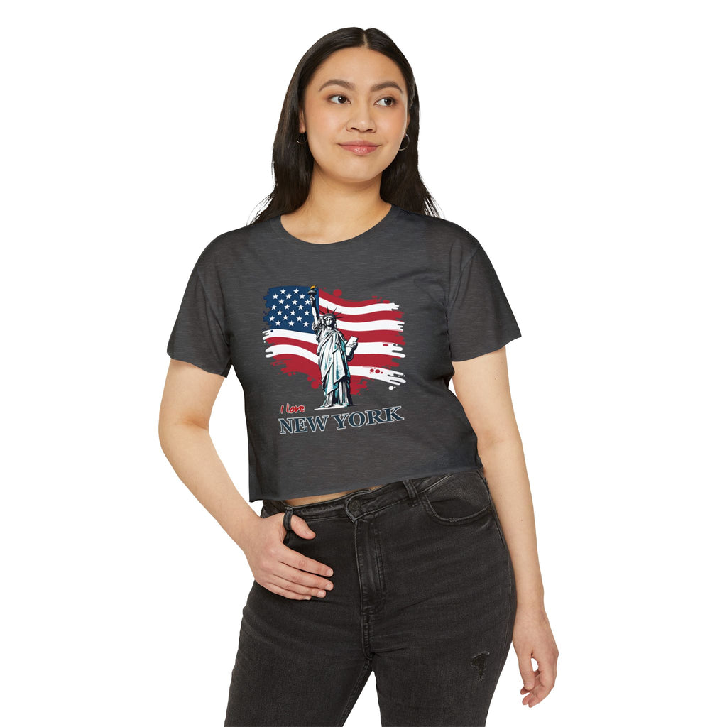 Woman wearing a charcoal t-shirt with a graphic design of the Statue of Liberty and American flag, standing on a white background.