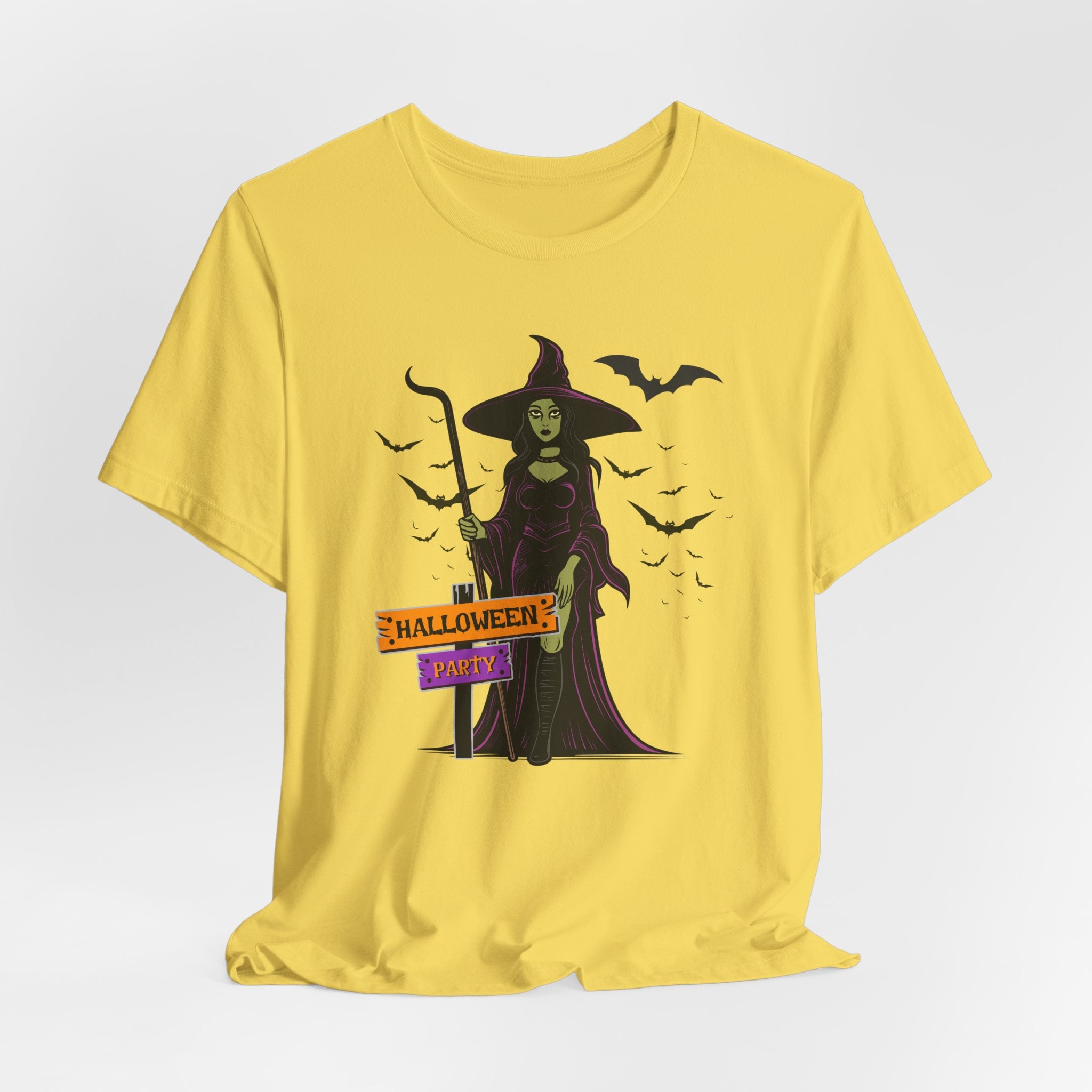 Maze yellow t-shirt with Halloween-themed design featuring a witch and bats on a white background