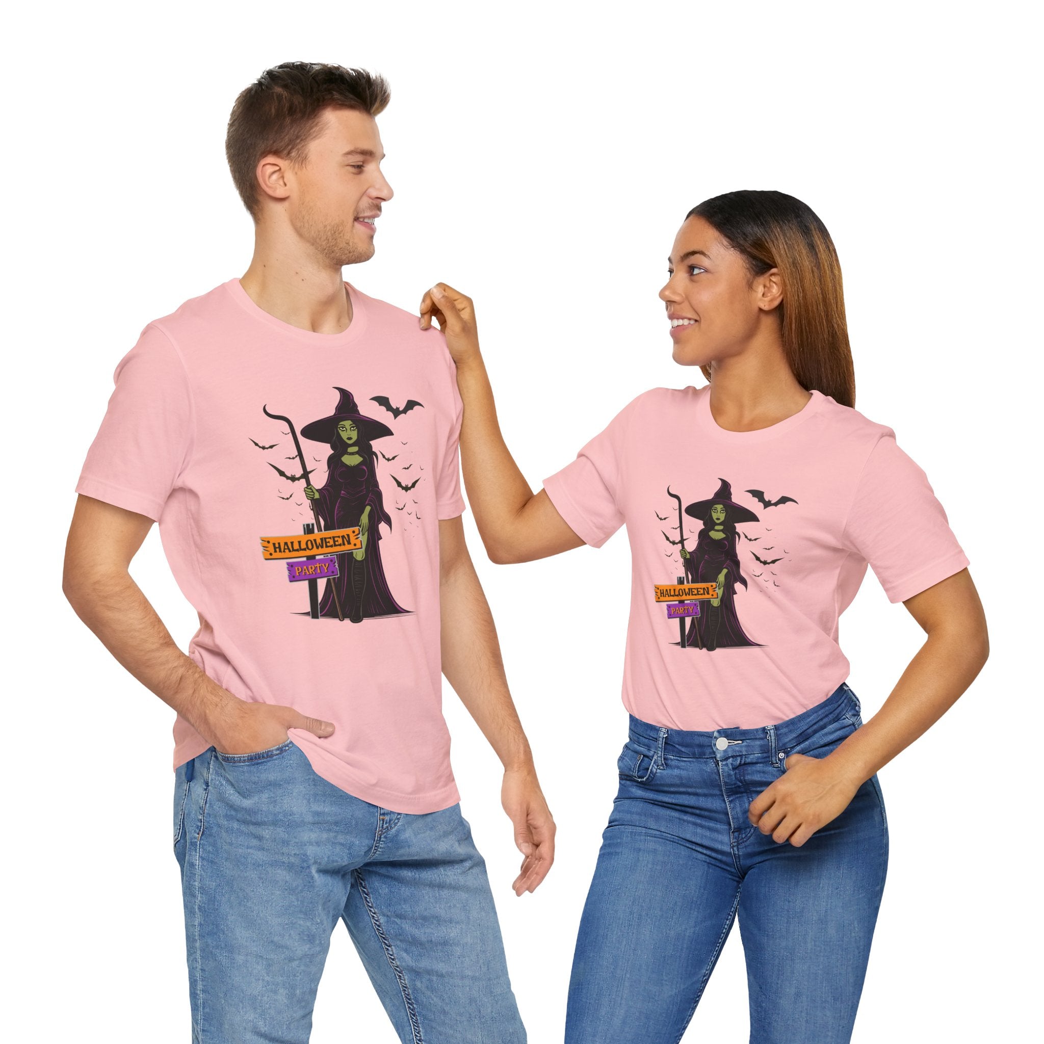 Two people wearing pink t-shirts with a witch graphic and text.