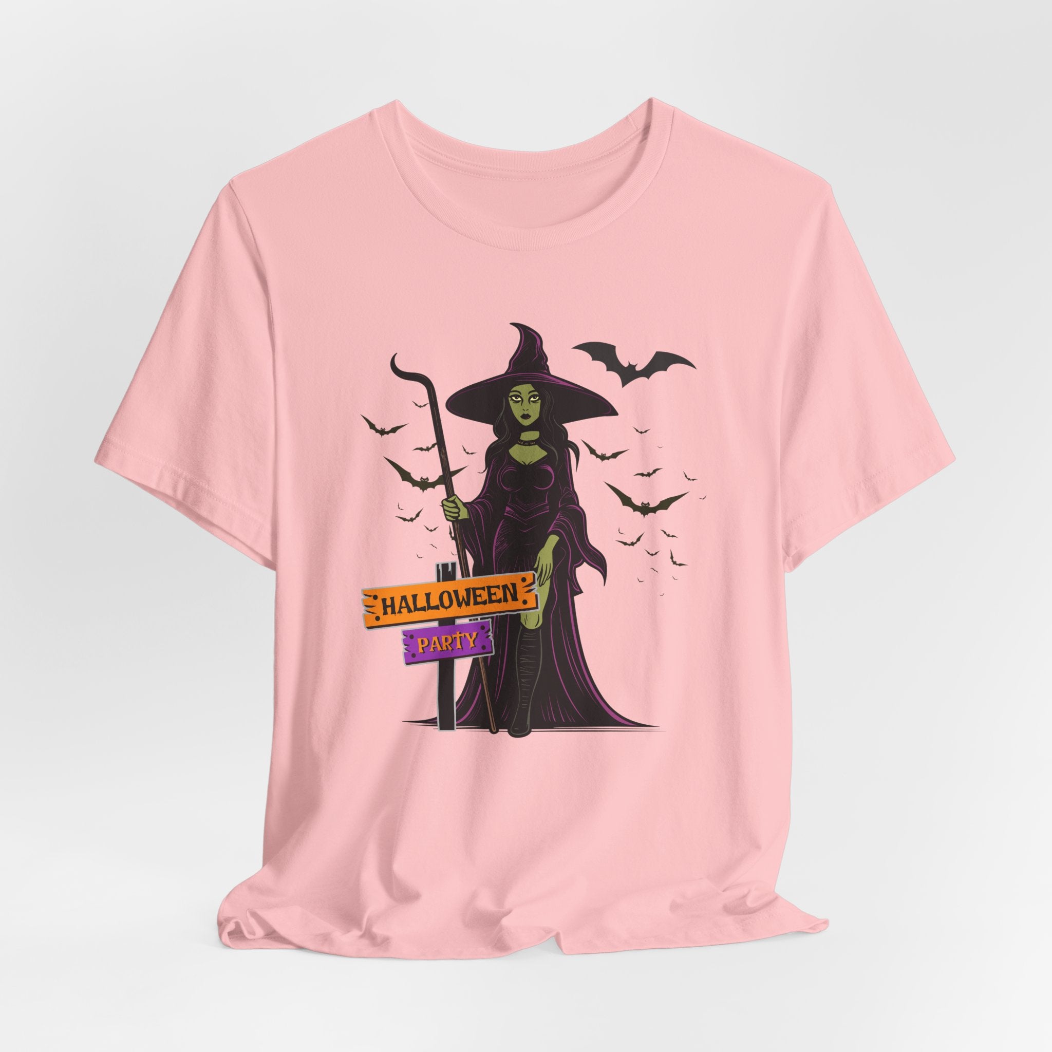 Pink t-shirt with Halloween-themed design featuring a witch and bats on a light gray background