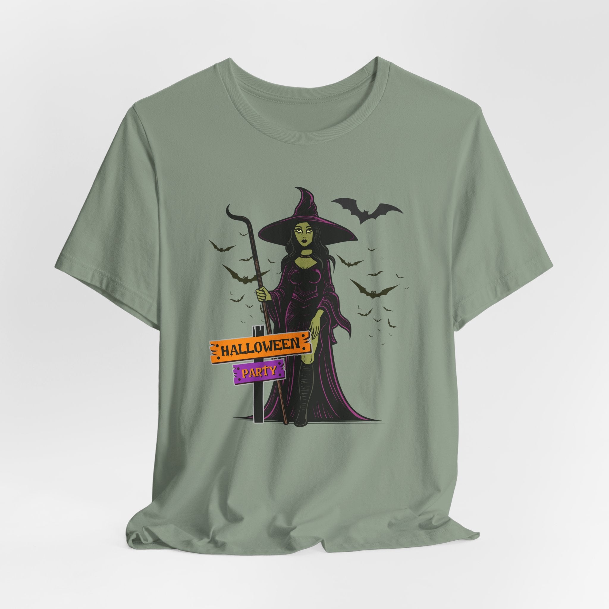 Sage green t-shirt with Halloween-themed design featuring a witch and bats on a white background