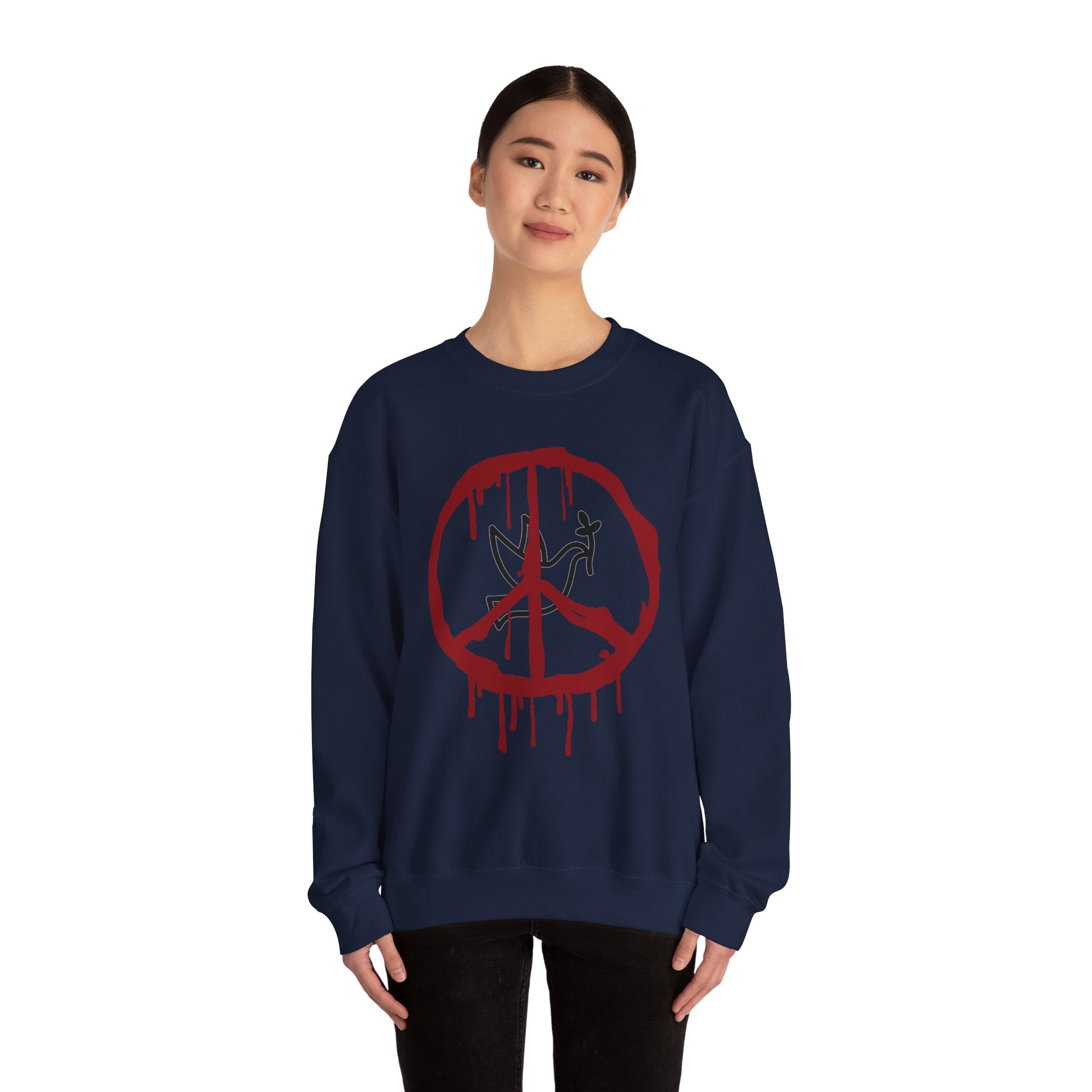 Person wearing a navy blue sweatshirt with a red peace symbol design on a white background