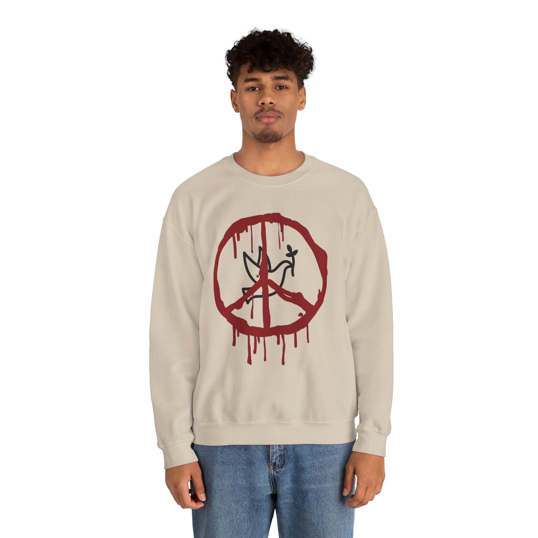 Person wearing a beige sweatshirt with a red peace symbol design on a white background