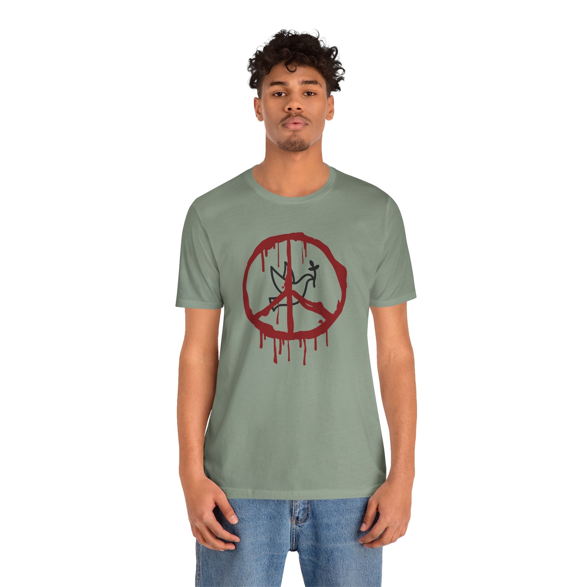 Person wearing a green t-shirt with a red peace symbol design on a white background
