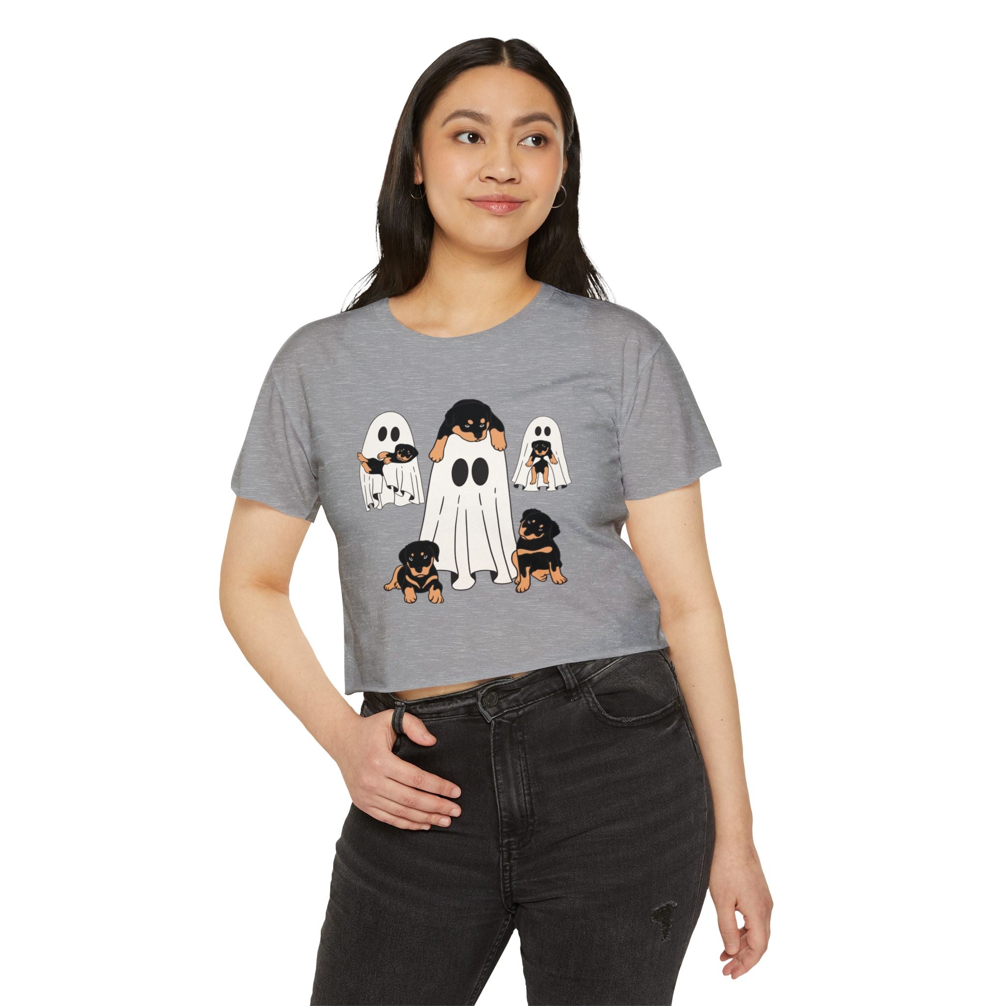 Woman wearing a gray t-shirt with ghost and dog illustrations on a white background