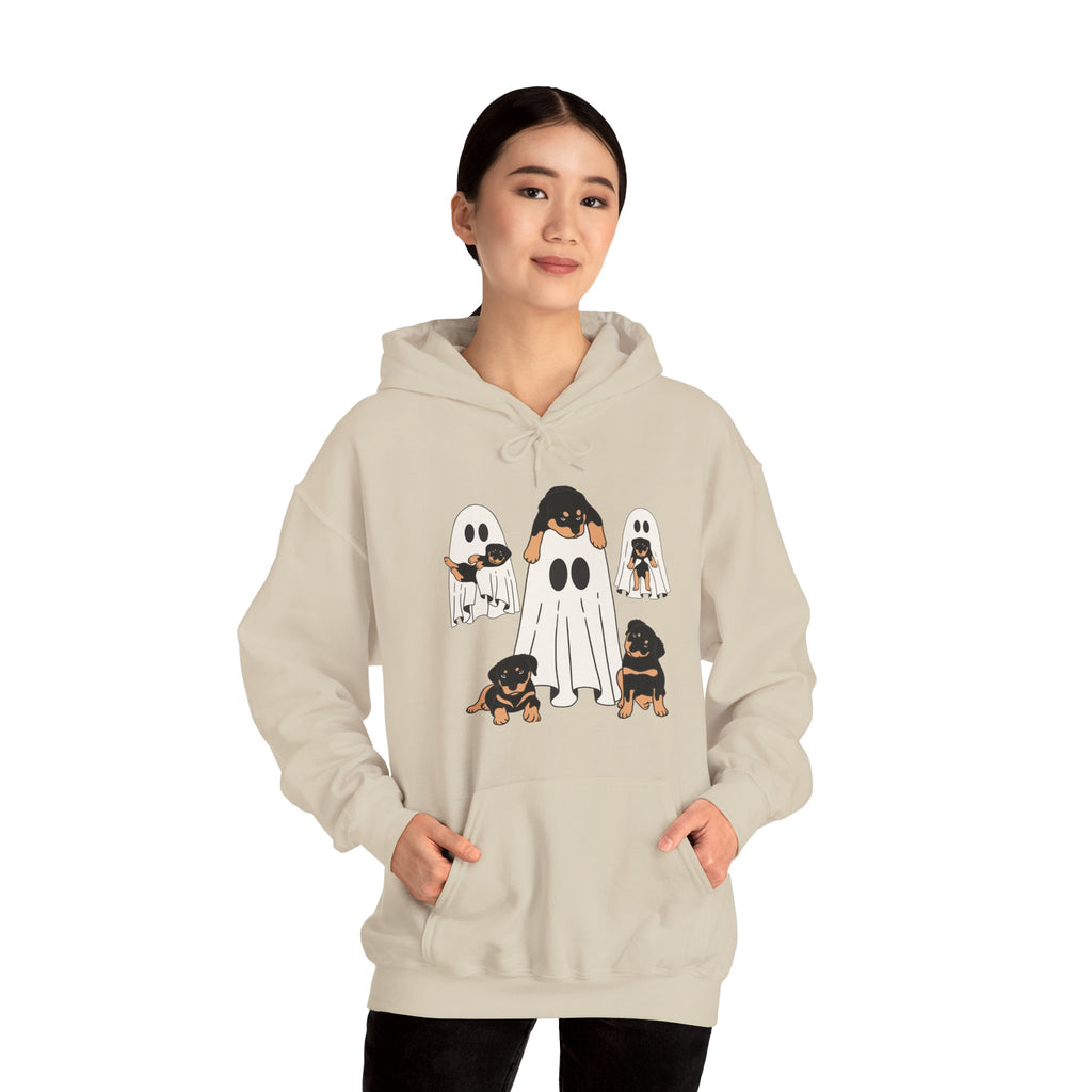 Person wearing a beige hoodie with ghost and dog design on a white background