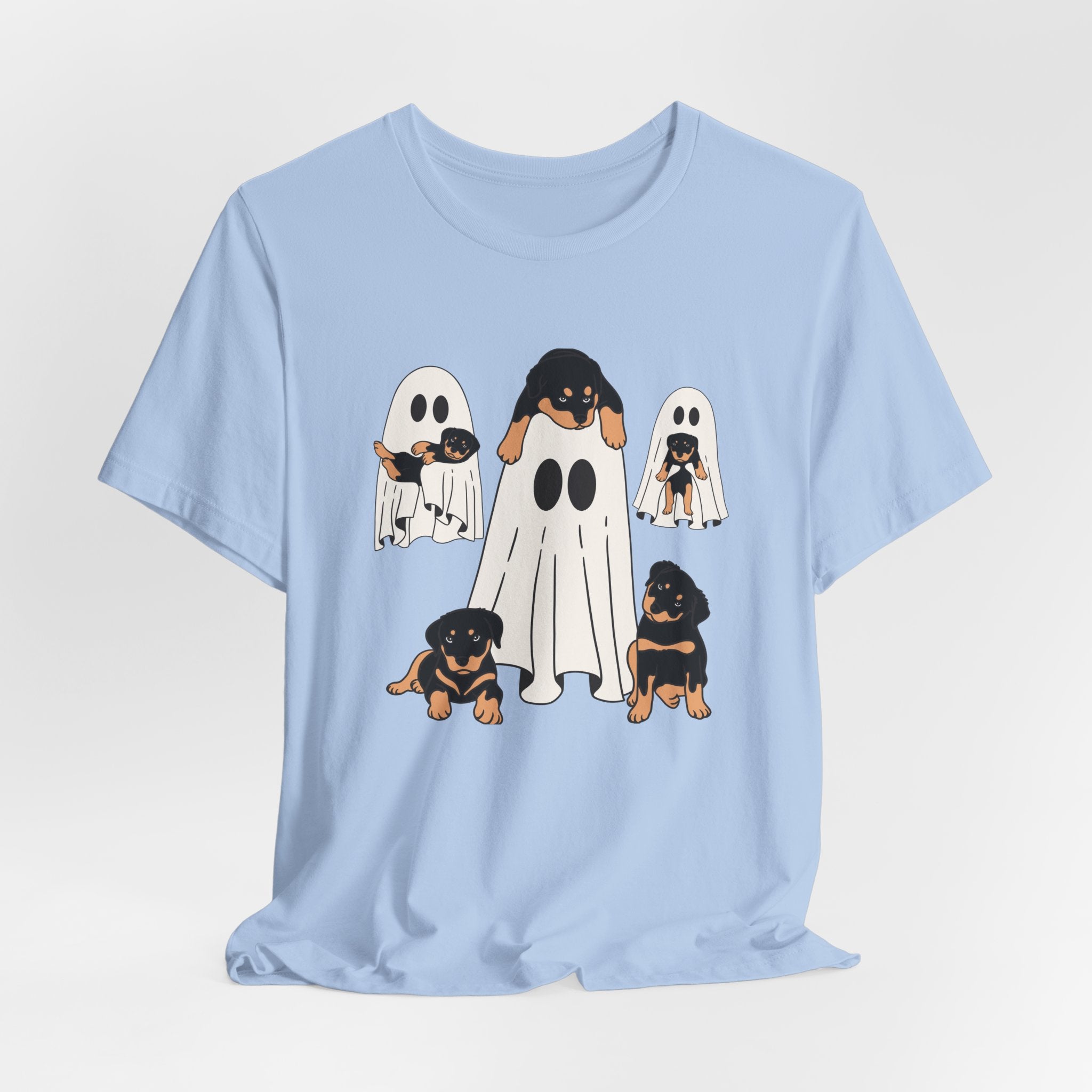 Light blue t-shirt with cartoon ghosts and dogs design on a white background