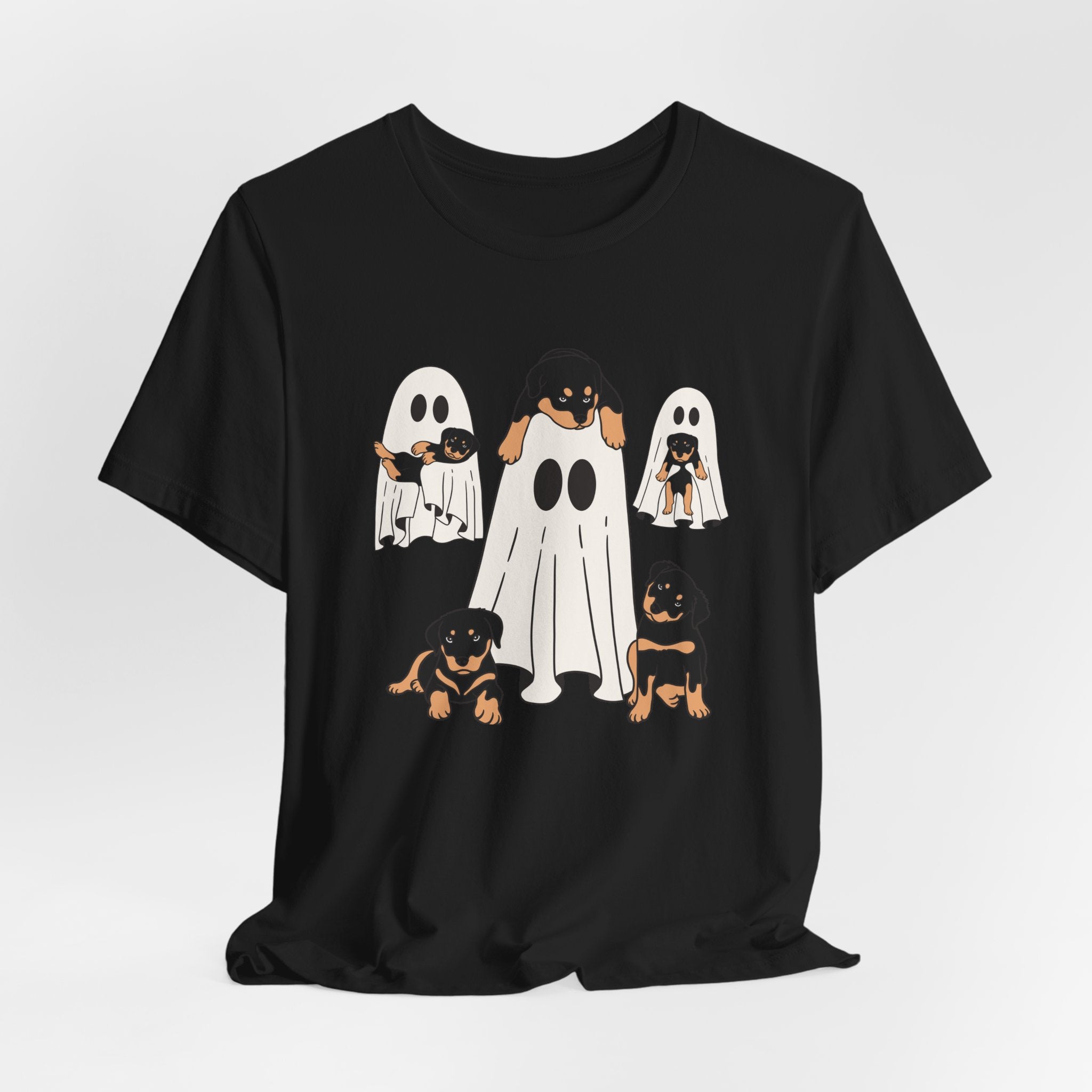Black t-shirt with Halloween-themed design of dogs in ghost costumes on a white background