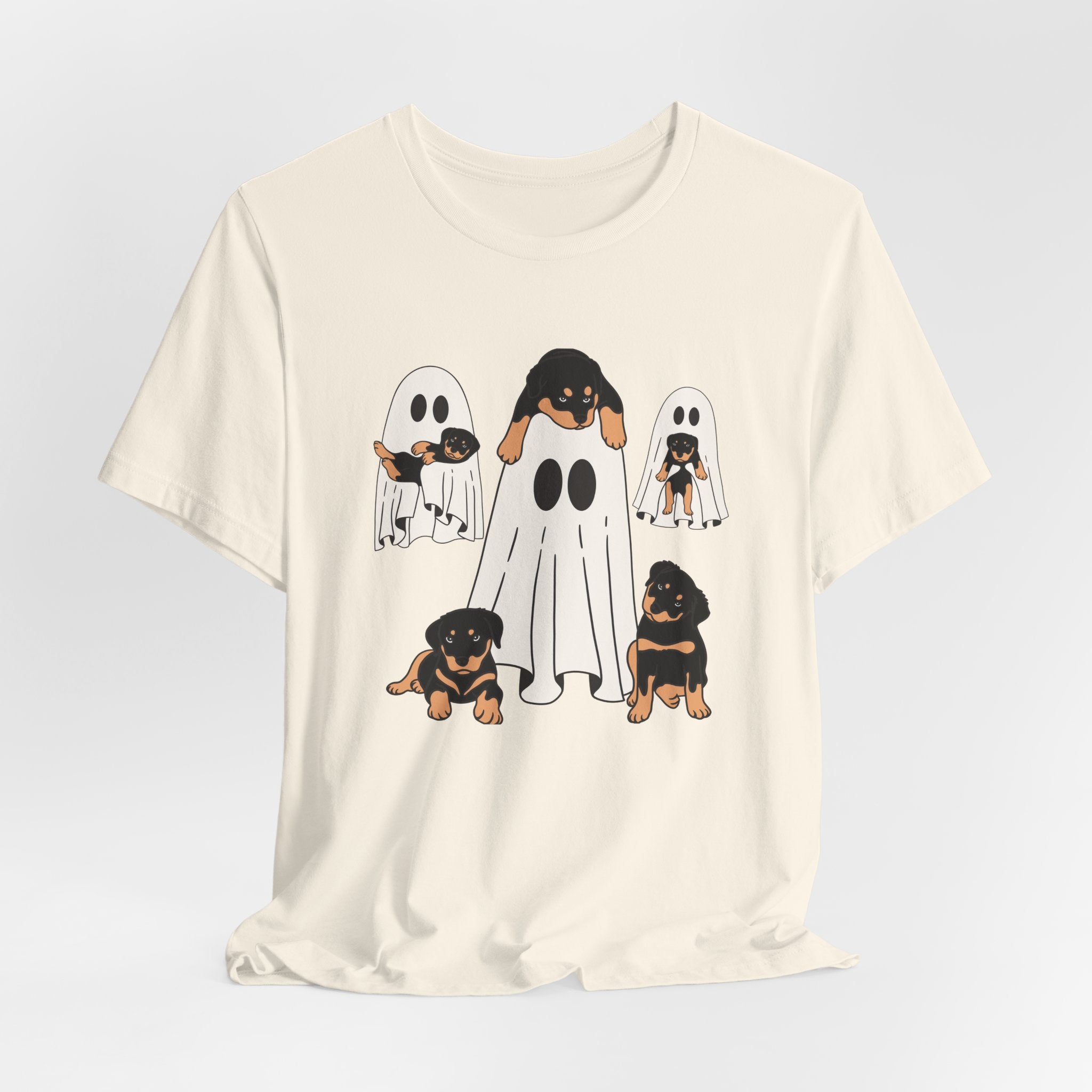 Ivory beige t-shirt with a graphic of dogs dressed as ghosts on a light gray background
