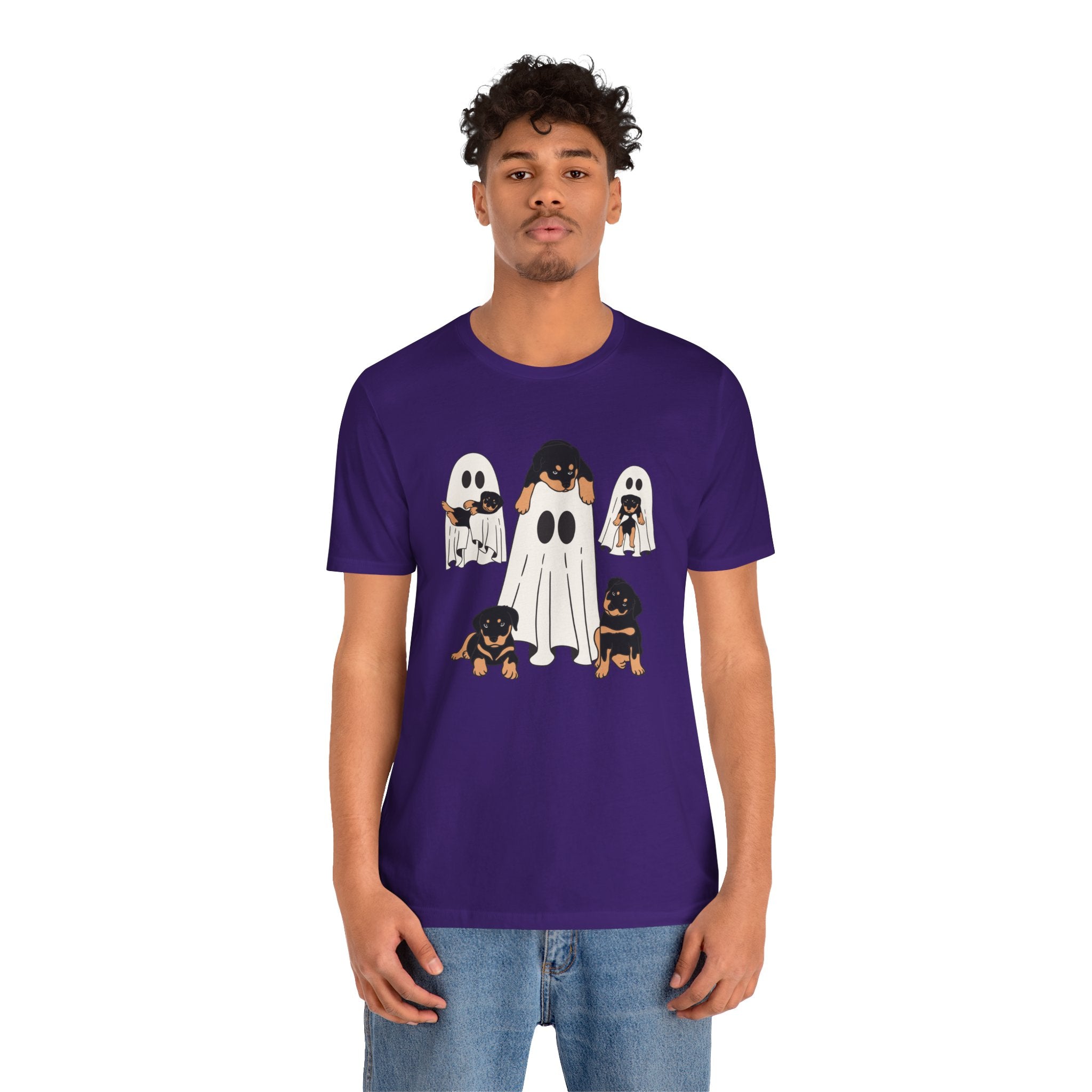 Person wearing a purple t-shirt with ghost and dog design on a white background