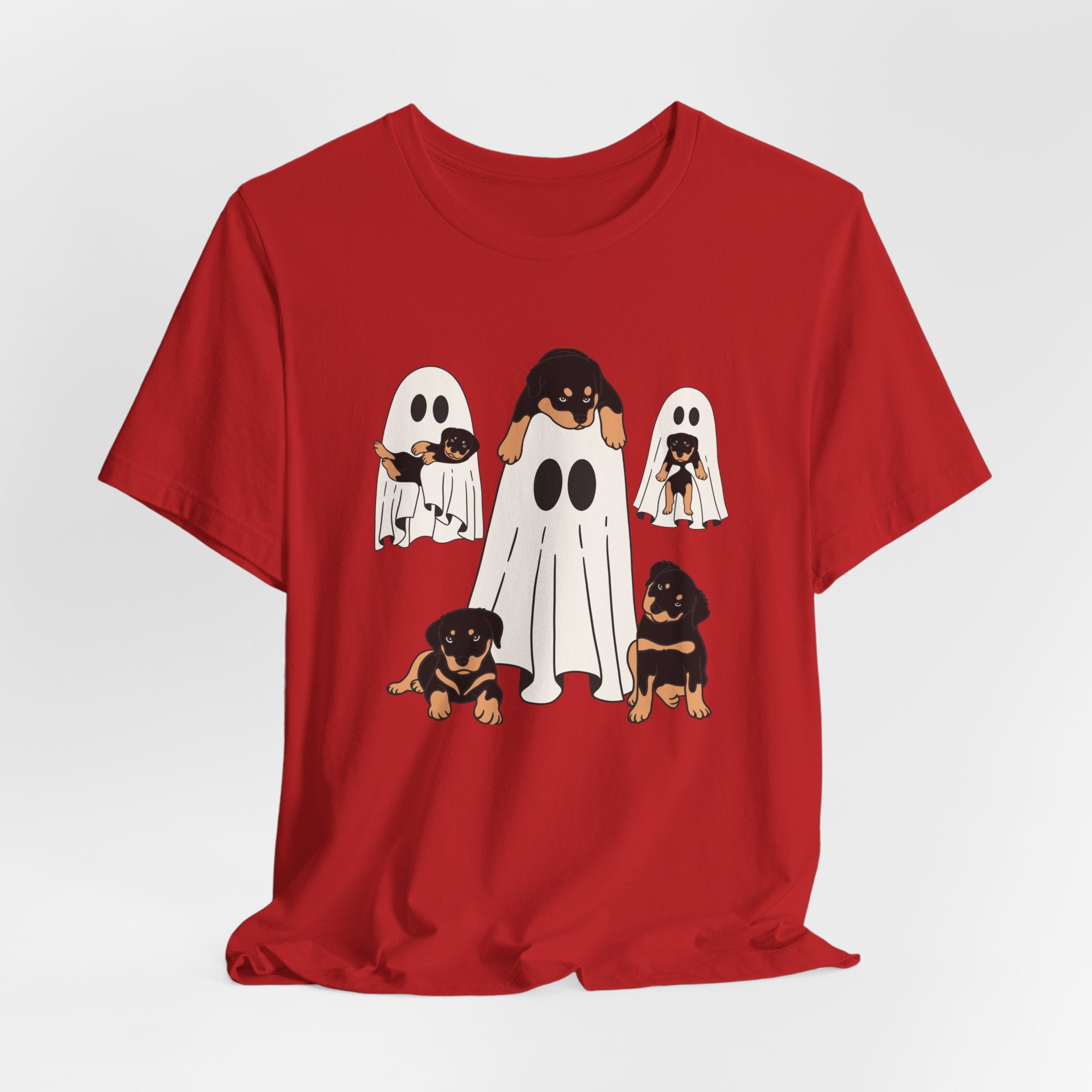 Red t-shirt with cartoon ghosts and dogs design on a white background