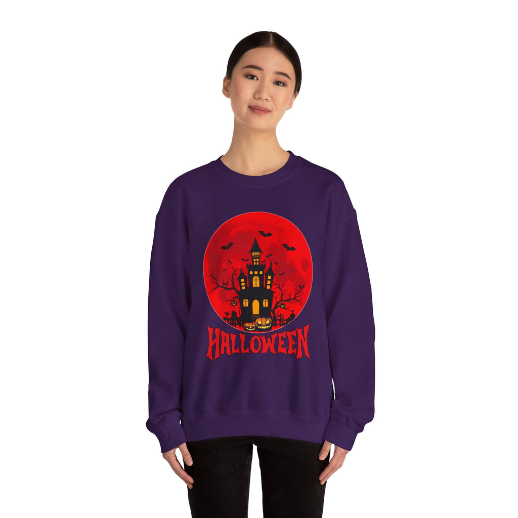 Person wearing a purple Halloween sweatshirt with a red moon and castle design.