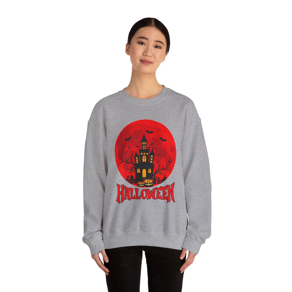 Person wearing a gray sweatshirt with a Halloween design featuring a castle and bats on a red circle.
