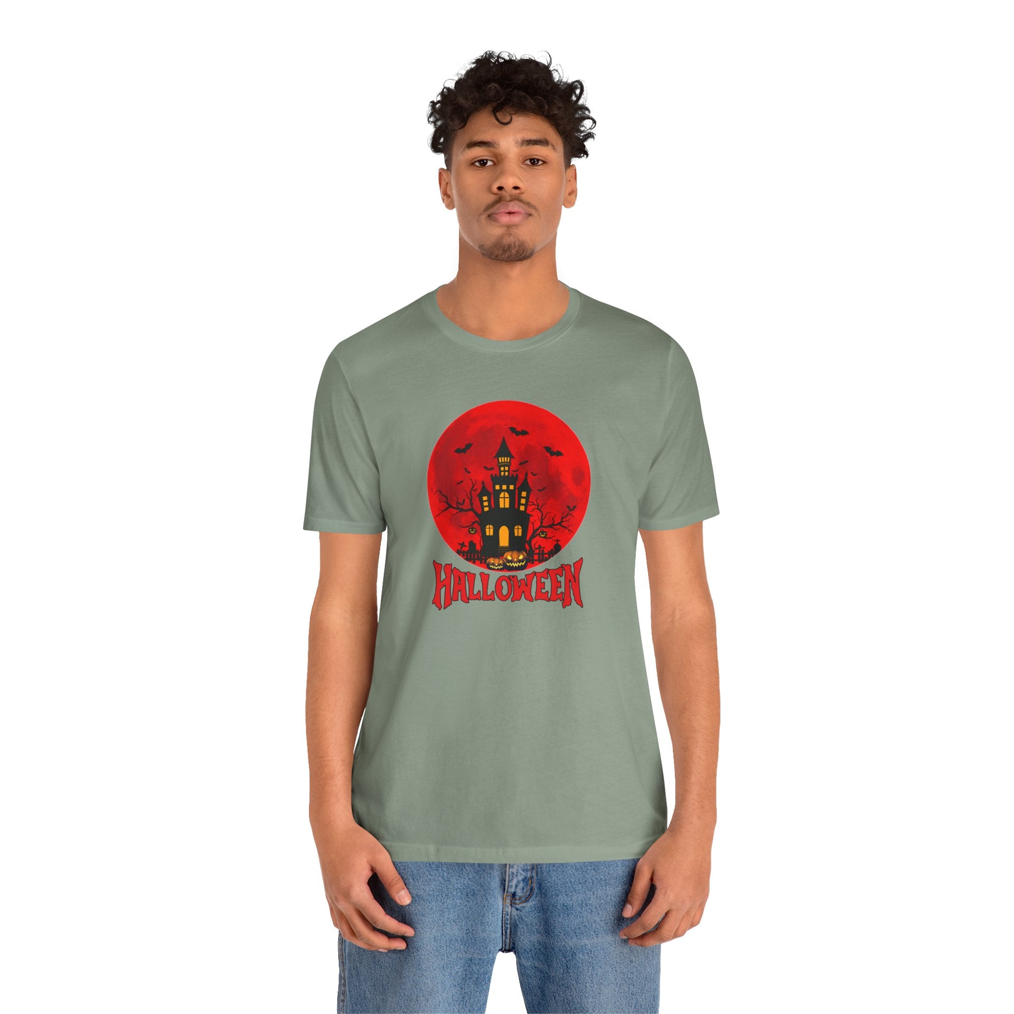 Person wearing a green t-shirt with a Halloween graphic design on a white background