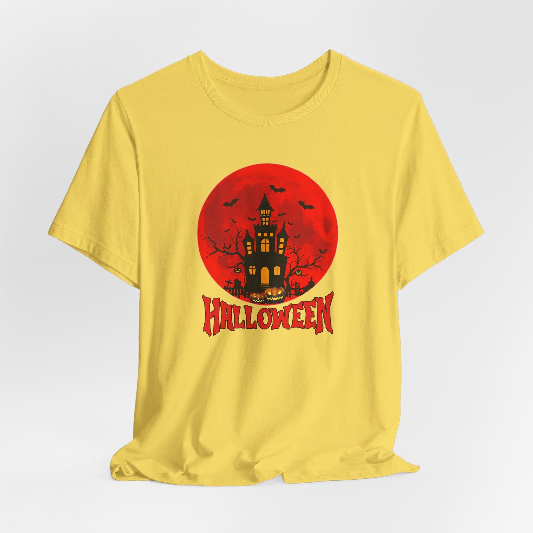 Yellow t-shirt with Halloween graphic featuring a castle and bats under the red moon and 'Halloween' text on a white background