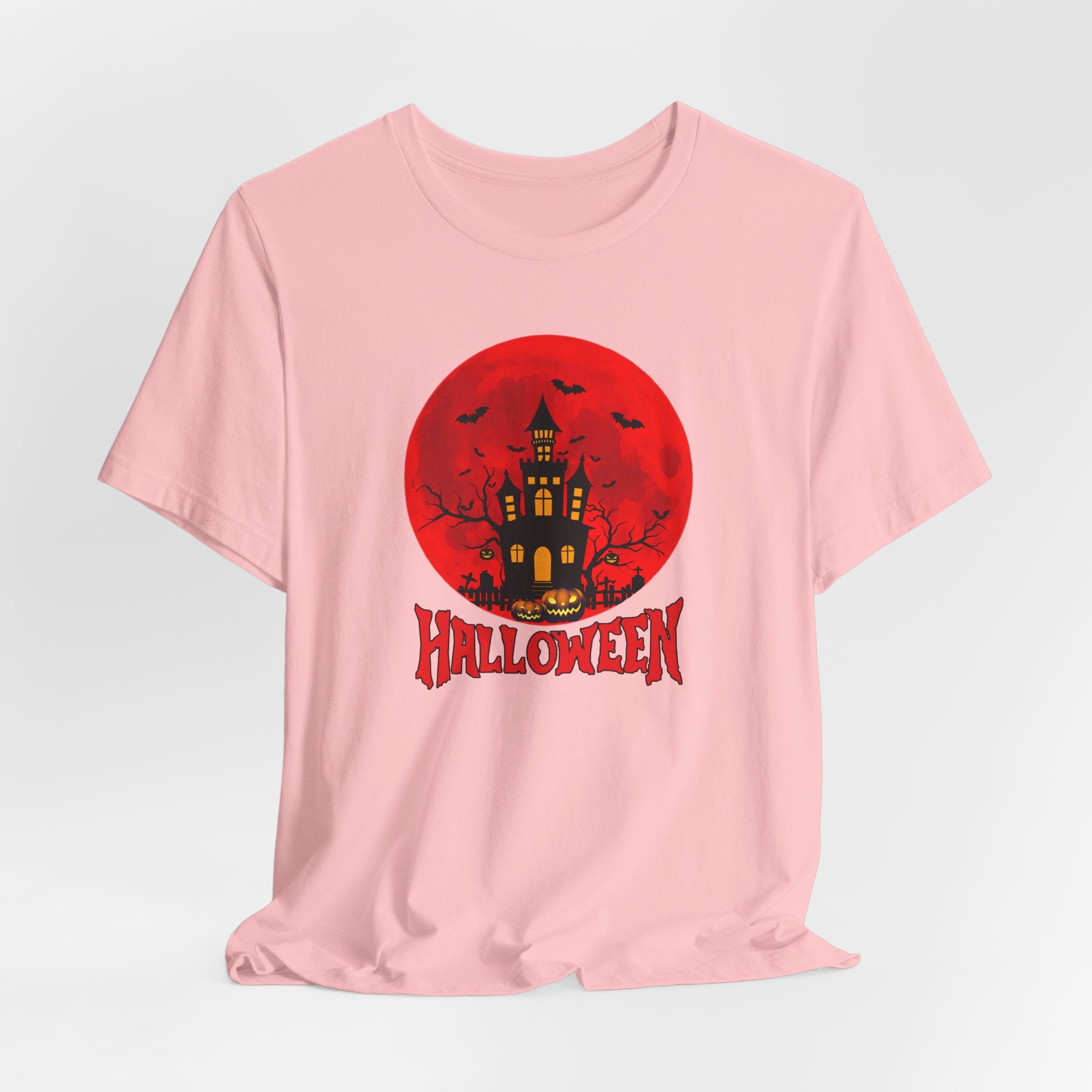 Pink t-shirt with Halloween design featuring a castle, pumpkin, bats under the red moon and 'Halloween' text on a light gray background