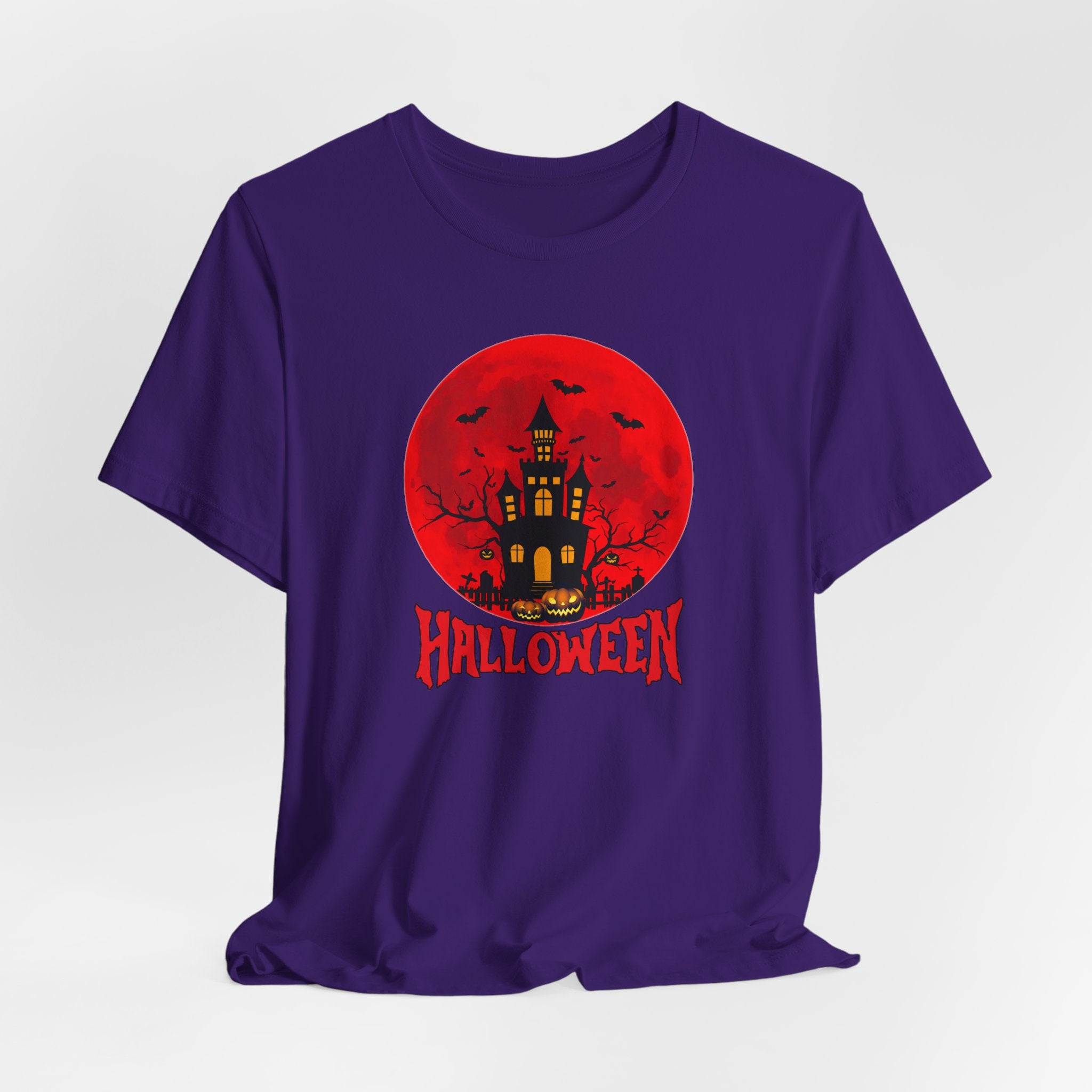 Purple t-shirt with Halloween design featuring a castle, bats, and pumpkins on a red moon background.