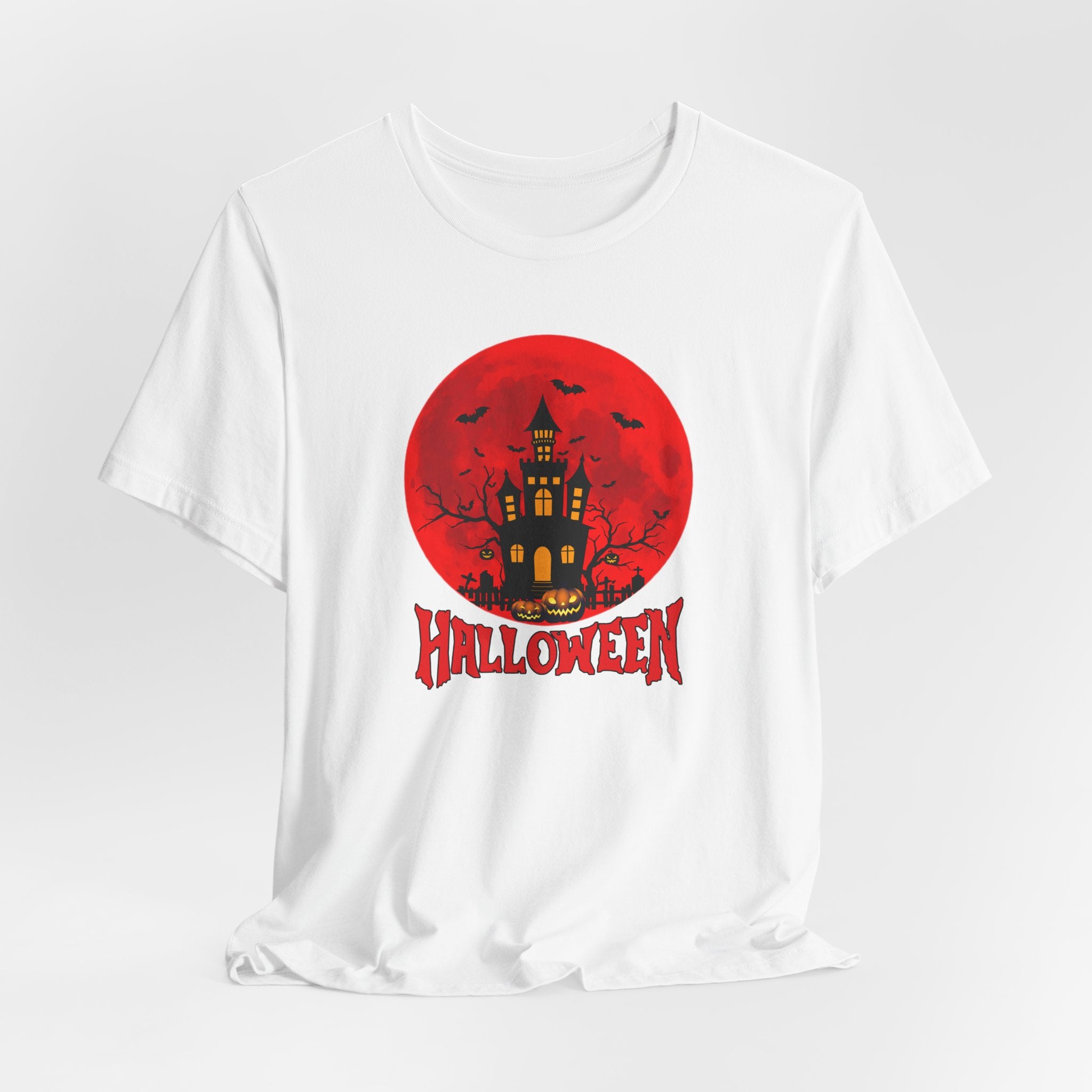 White t-shirt with Halloween graphic featuring a castle and bats under the red moon and 'Halloween' text on a red circle.