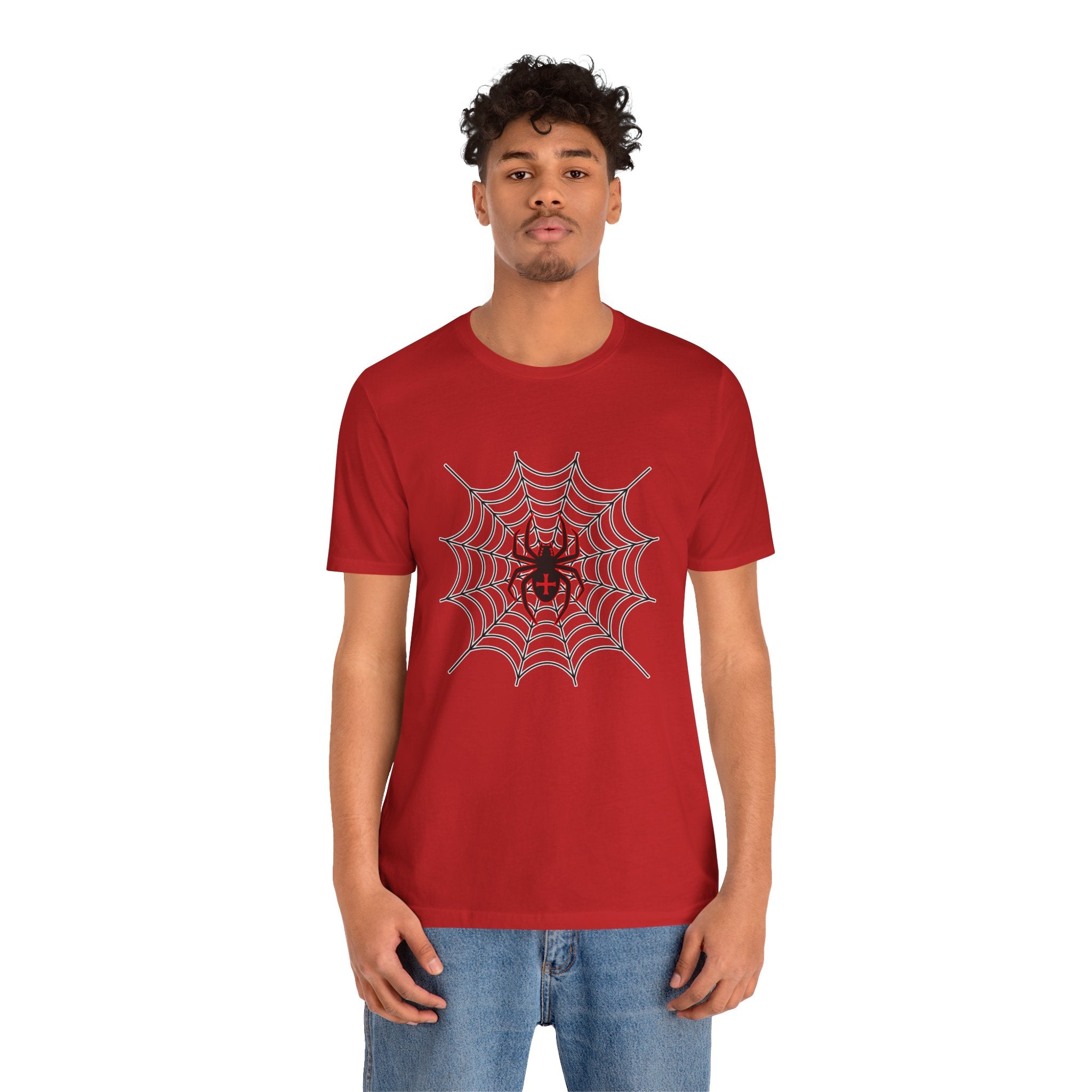 Person wearing a red t-shirt with a spider and web design on a white background