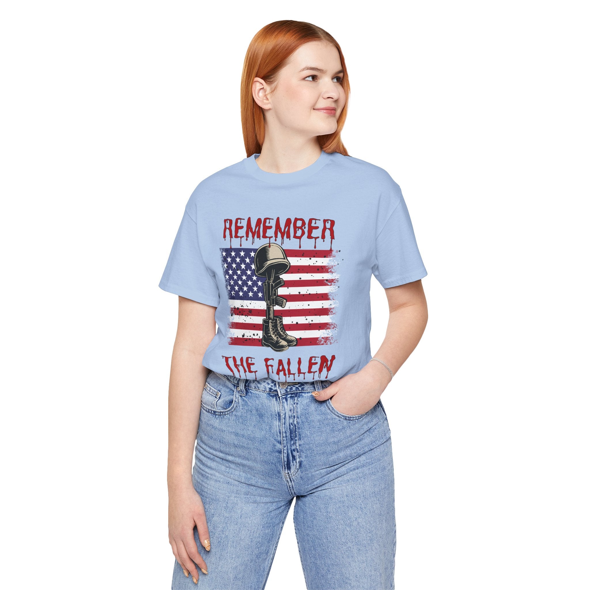 Person wearing a light blue t-shirt with a graphic design and text on a white background