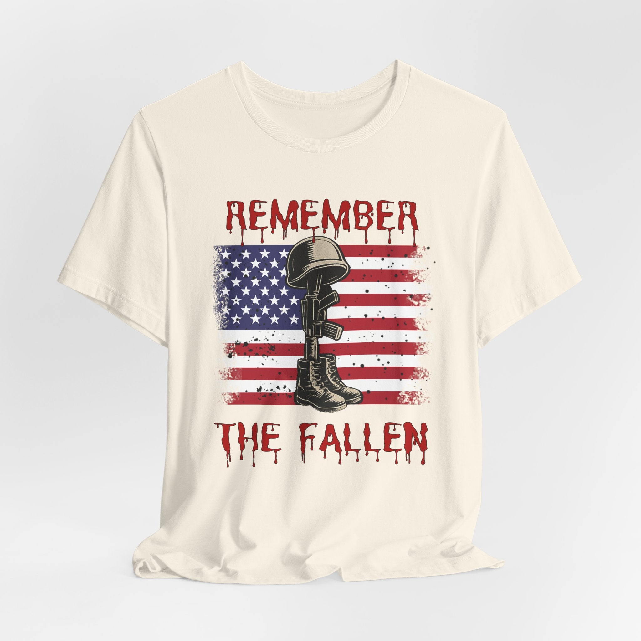 Ivory beige t-shirt with vintage American flag and military gear themed design with remember the fallen text on a white background