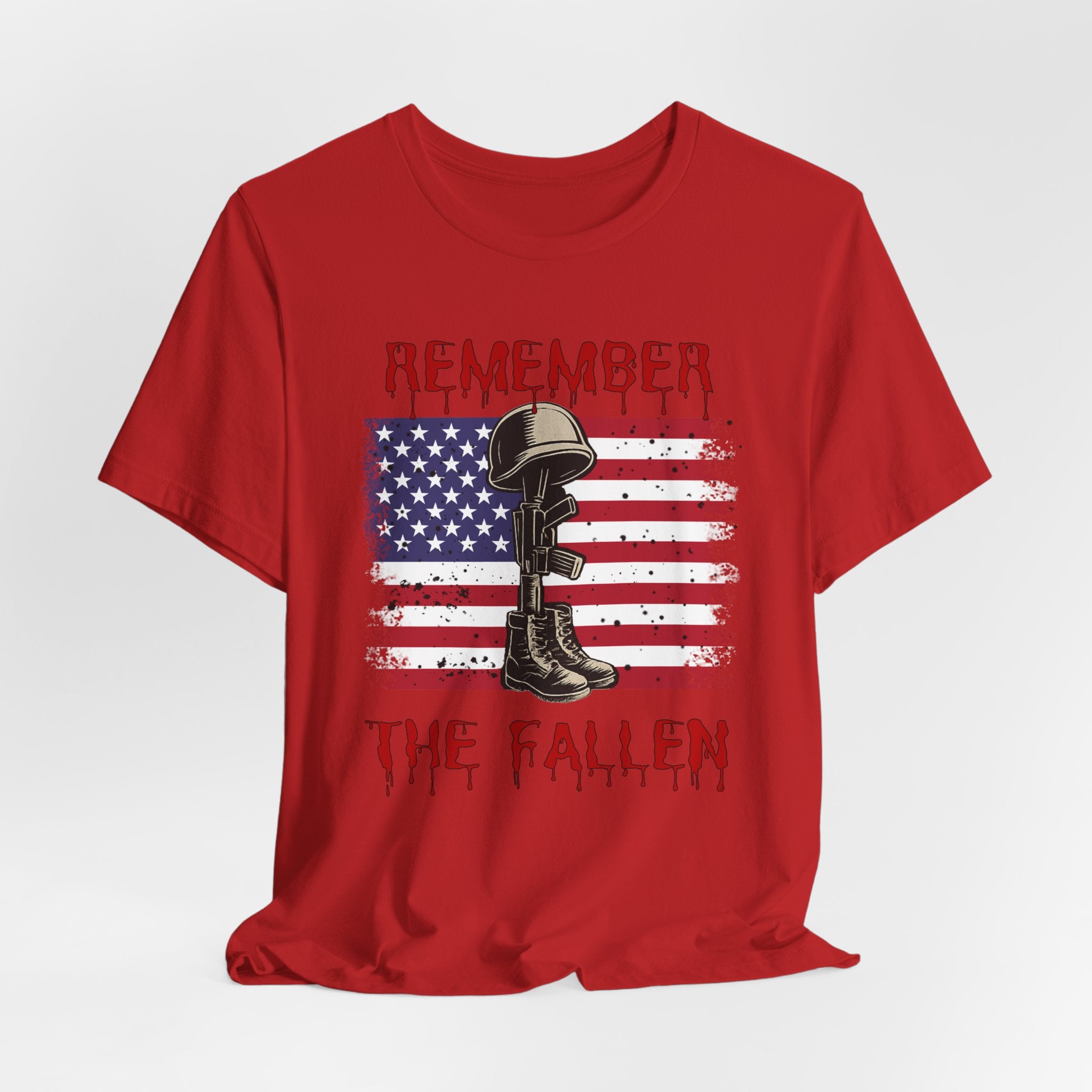 Red t-shirt with vintage American flag and military gear themed design with remember the fallen text on a white background