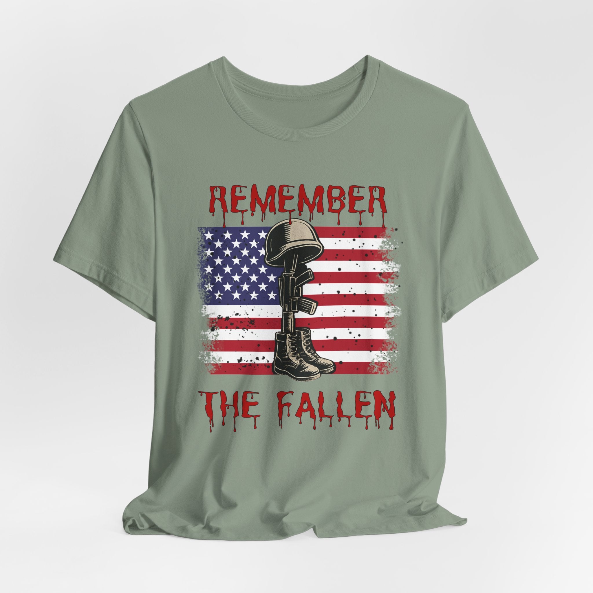 Sage green t-shirt with vintage American flag and military gear themed design with remember the fallen text on a white background