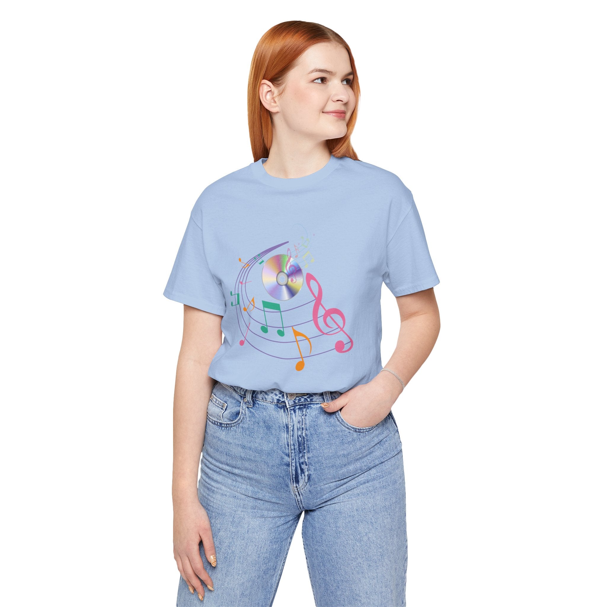 Person wearing a light blue t-shirt with colorful music note design on a white background