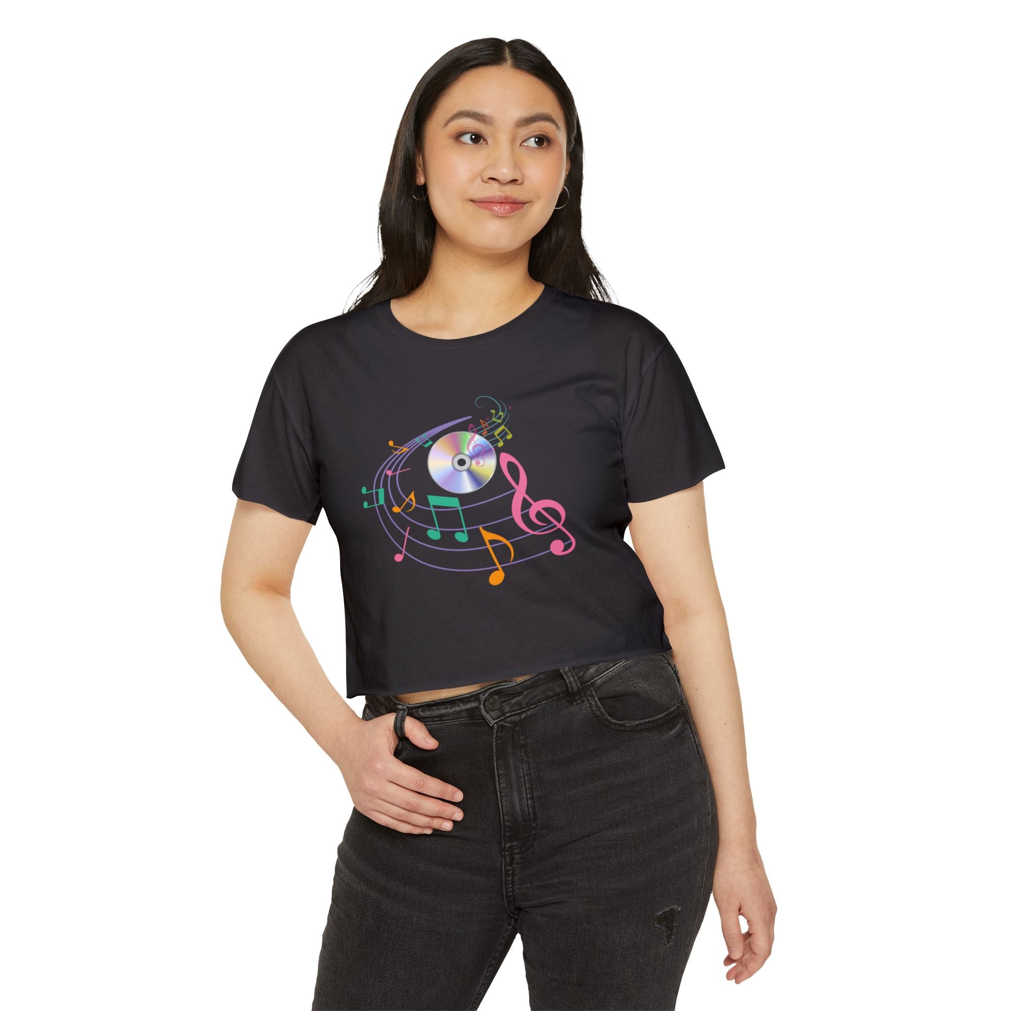 Woman wearing a black t-shirt with colorful music notes and a CD design on a white background