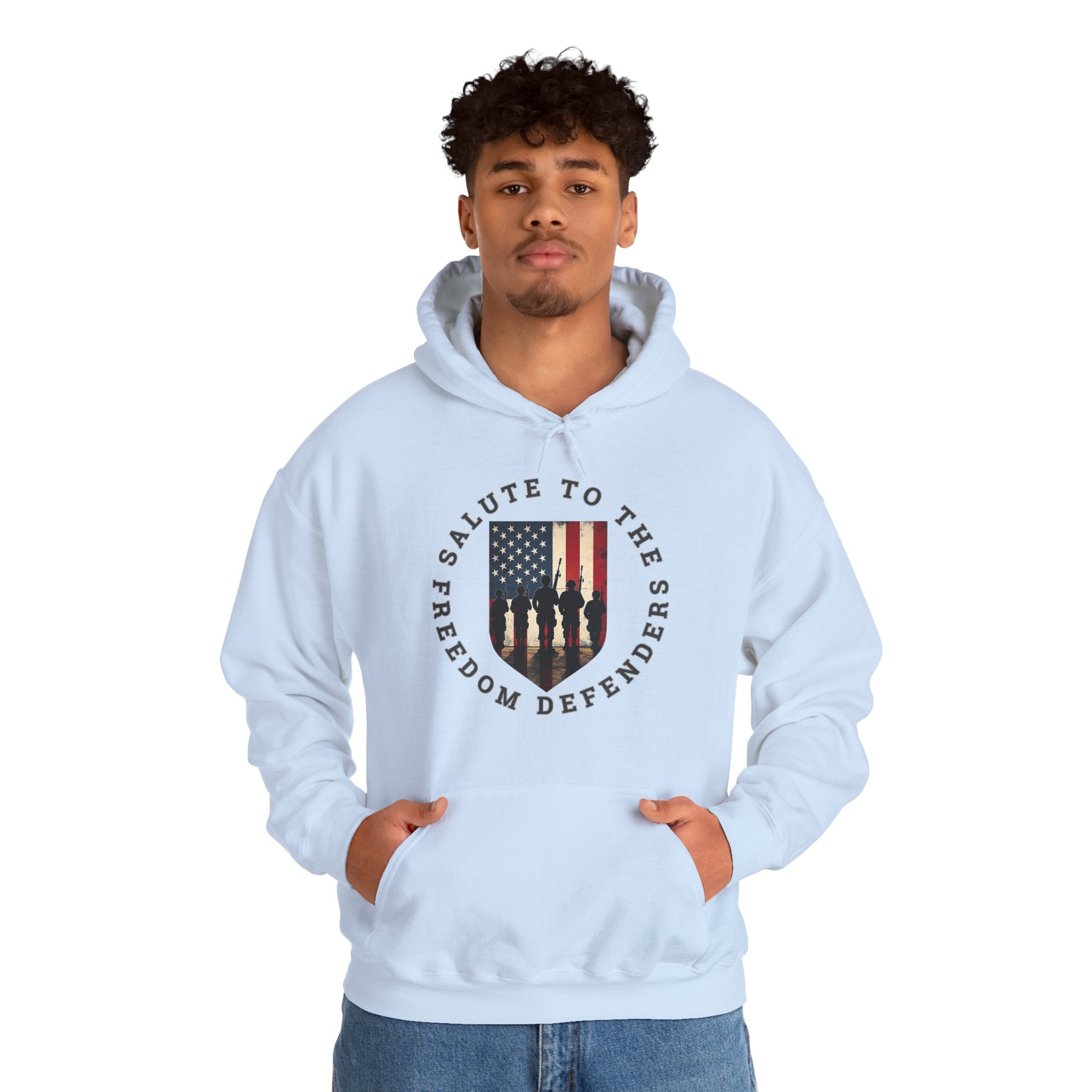 Person wearing a light blue hoodie with a graphic design of vintage USA flag with soldiers and "salute to the freedom defenders" text on a white background