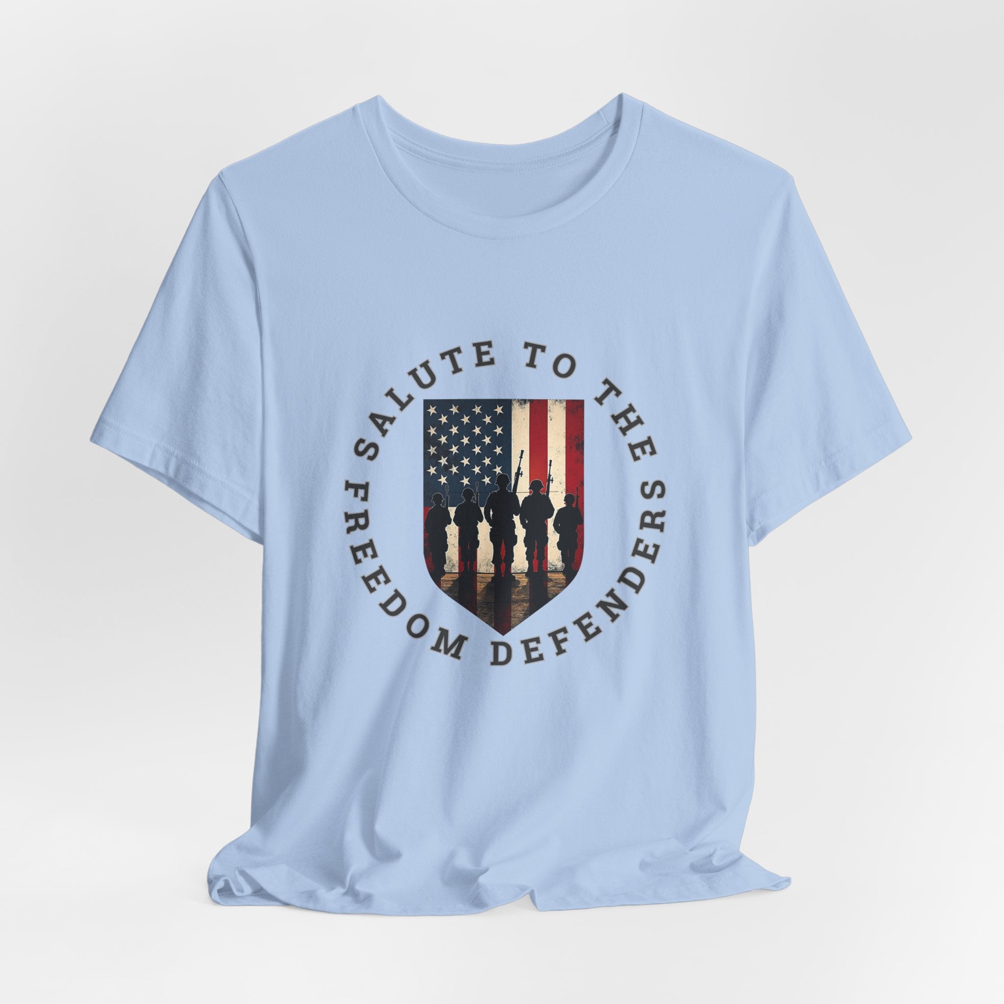 Baby light blue t-shirt with 'Salute to the Freedom Defenders' design featuring an American flag and silhouette of soldiers on a white background.