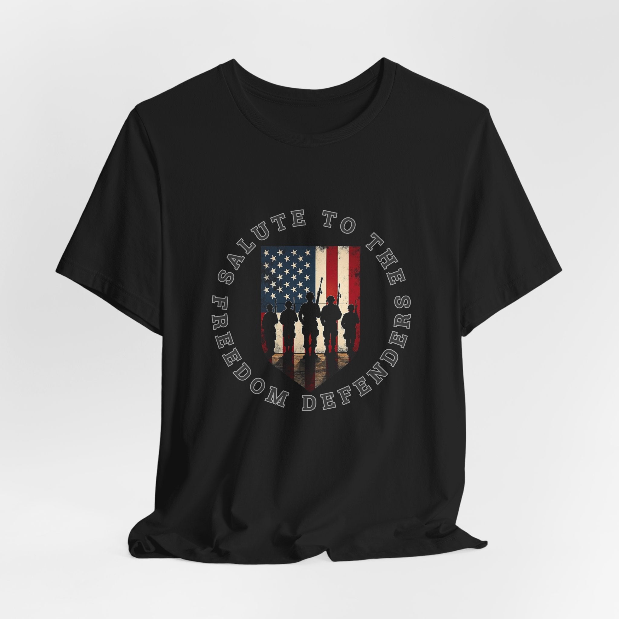 Black t-shirt with 'Salute to the Freedom Defenders' design featuring an American flag and silhouette of soldiers on a white background.