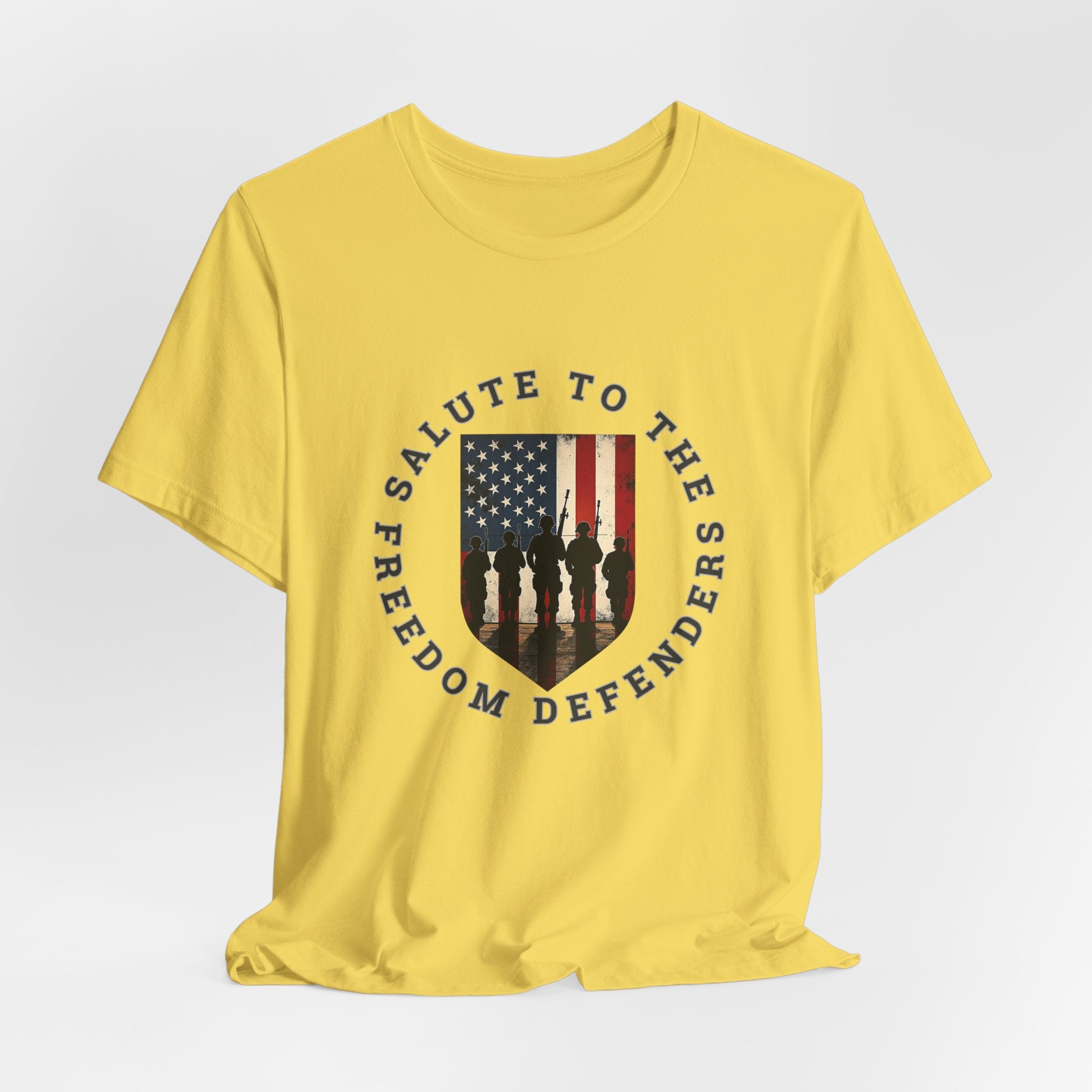 Maze yellow t-shirt with 'Salute to the Freedom Defenders' design featuring an American flag and silhouette of soldiers on a white background.